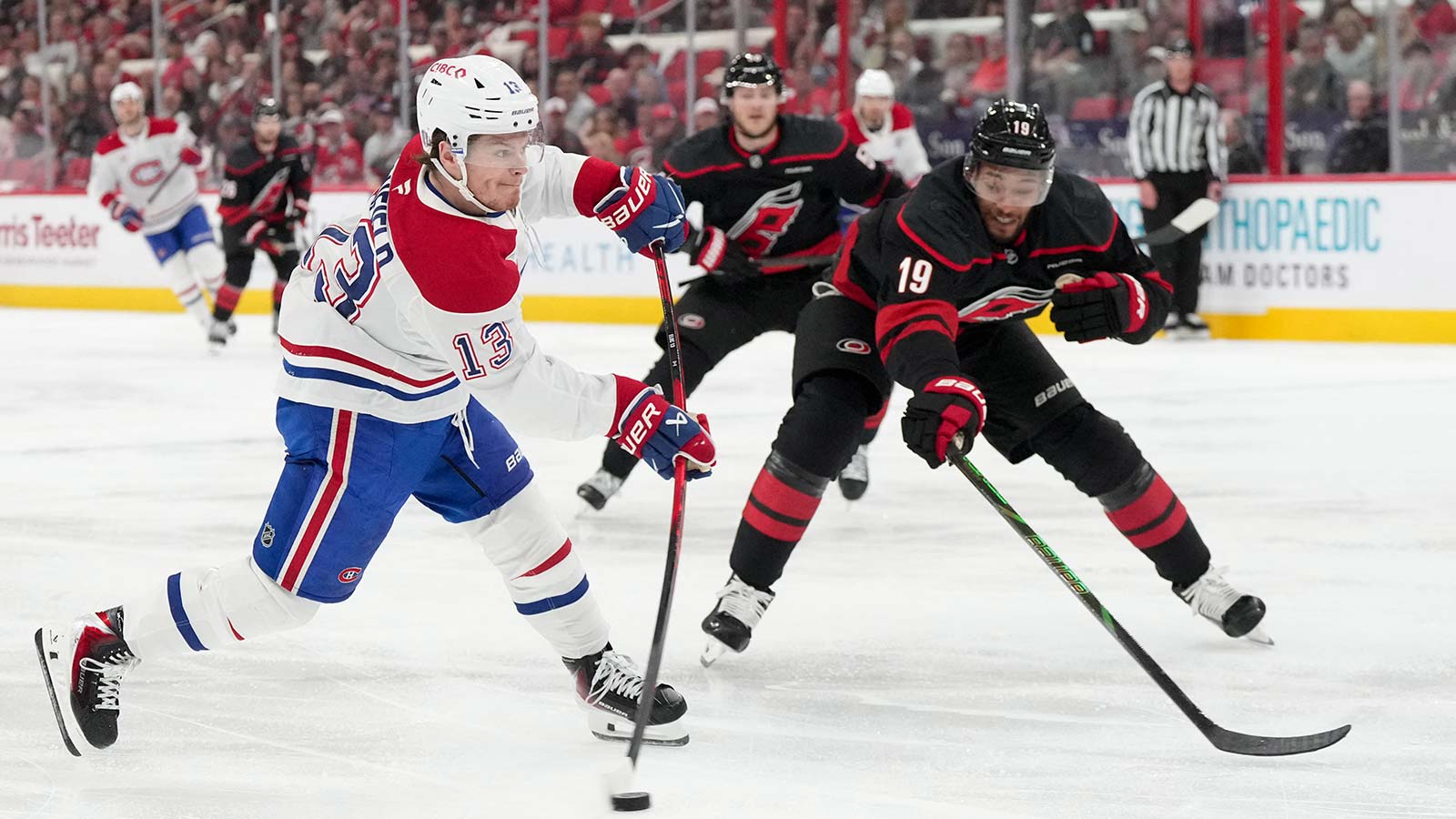 Montreal Canadiens right wing Cole Caufield (13) shoots the puck defended by Carolina Hurricanes defenseman K'andre Miller (19) during the second period in game one of the Eastern Conferene Final of the 2026 Stanley Cup Playoffs at Lenovo Center.