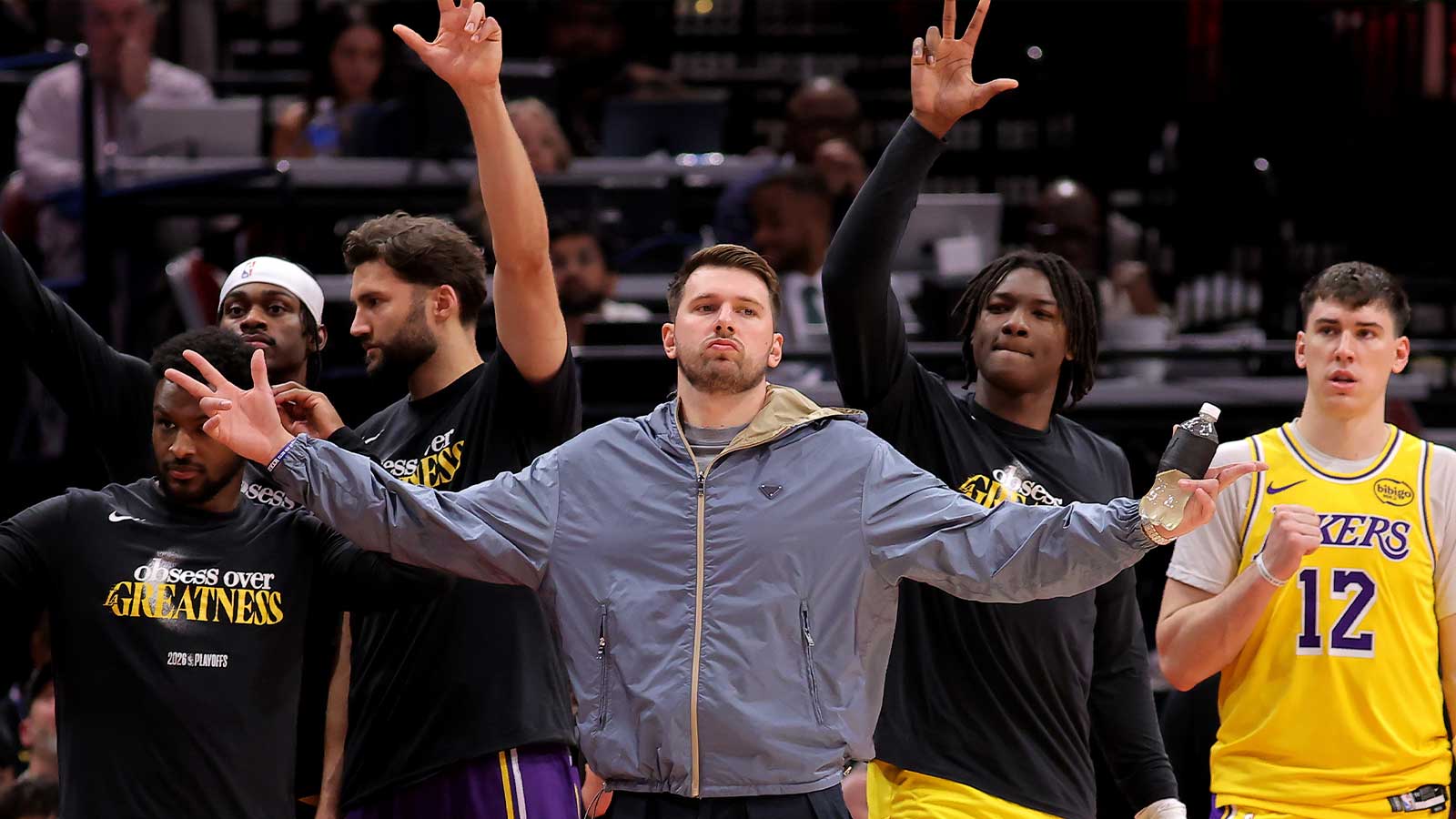 Lakers guard Luka Doncic (77, middle) reacts after a made basket against the Houston Rockets during the fourth quarter of game six of the first round of the 2026 NBA Playoffs at Toyota Center