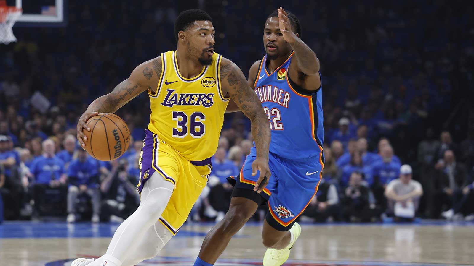 Lakers guard Marcus Smart (36) moves the ball around Oklahoma City Thunder guard Cason Wallace (22) in the first half during game one of the second round of the 2026 NBA Playoffs at Paycom Center