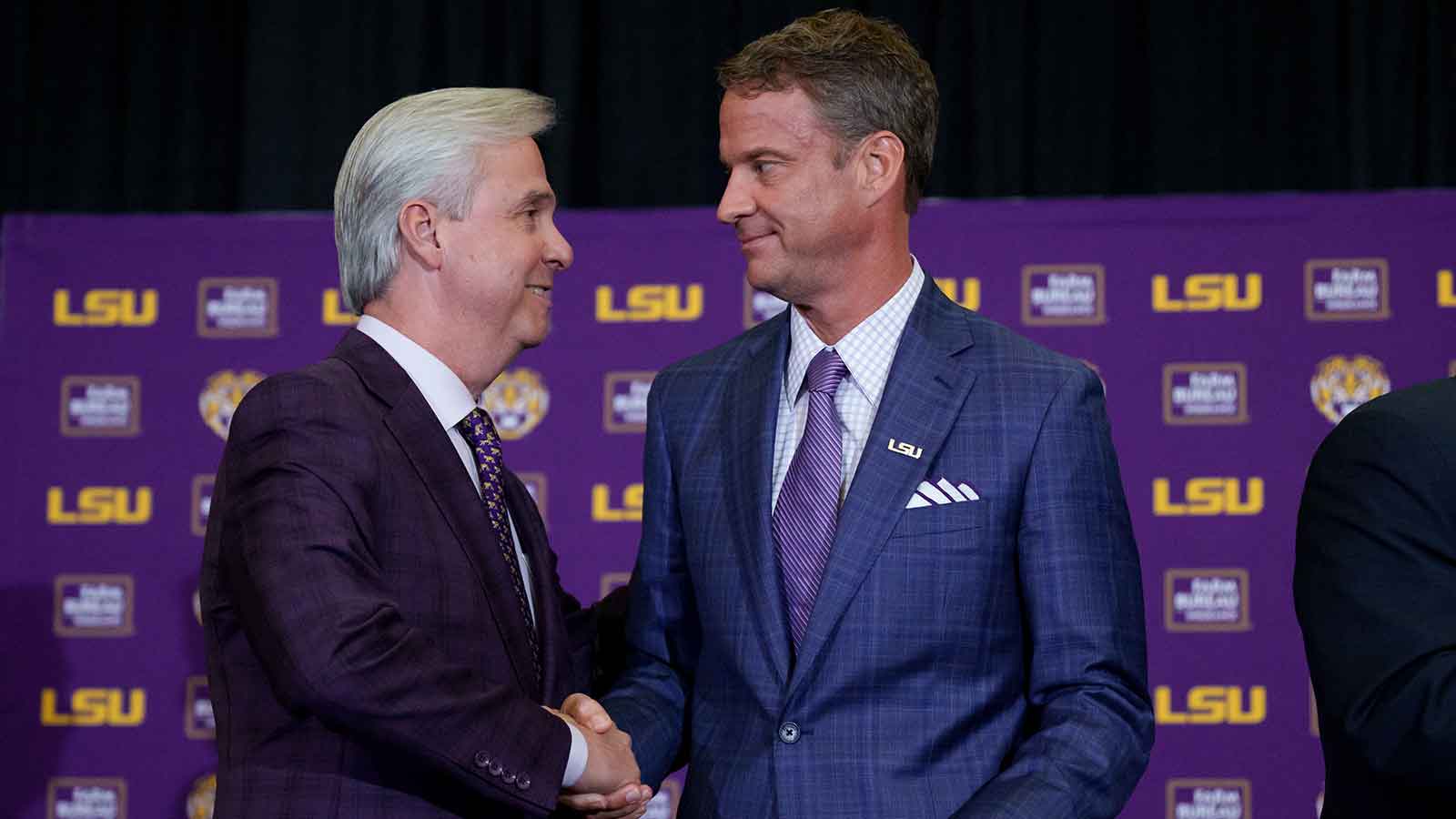 LSU president Wade Rousse, left, and LSU new head coach Lane Kiffin greet each other at South Stadium Club at Tiger Stadium.
