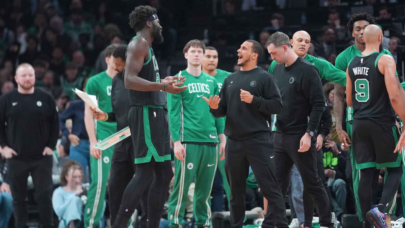 Boston Celtics head coach Joe Mazzulla speaks with Boston Celtics center Neemias Queta (88) at a break during the first half against the Toronto Raptors at TD Garden.