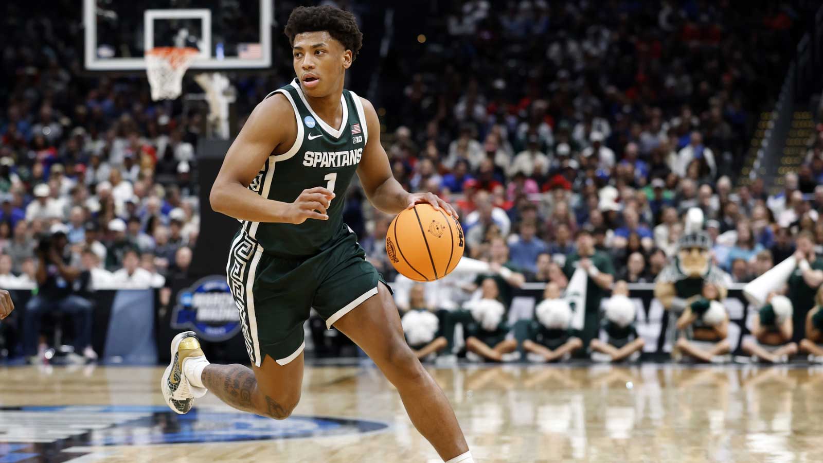 Michigan State Spartans guard Jeremy Fears Jr. (1) dribbles the ball against the UConn Huskies in the first half during a Sweet Sixteen game of the East Regional of the men's 2026 NCAA Tournament at Capital One Arena.