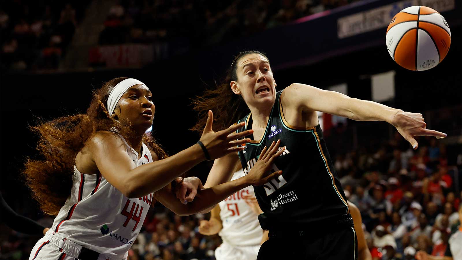 Washington Mystics forward Kiki Iriafen (44) and New York Liberty forward Breanna Stewart (30) battle for a loose ball at CareFirst Arena.