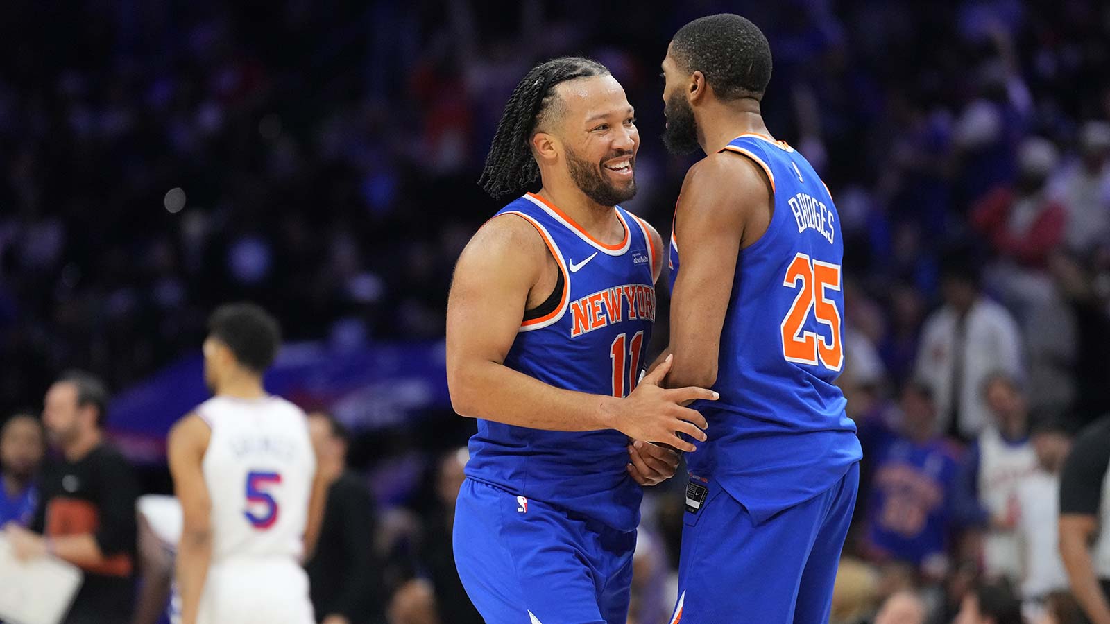 New York Knicks guard Jalen Brunson (11) reacts with guard Mikal Bridges (25) against the Philadelphia 76ers in the third quarter during game four of the second round of the 2026 NBA Playoffs at Xfinity Mobile Arena.