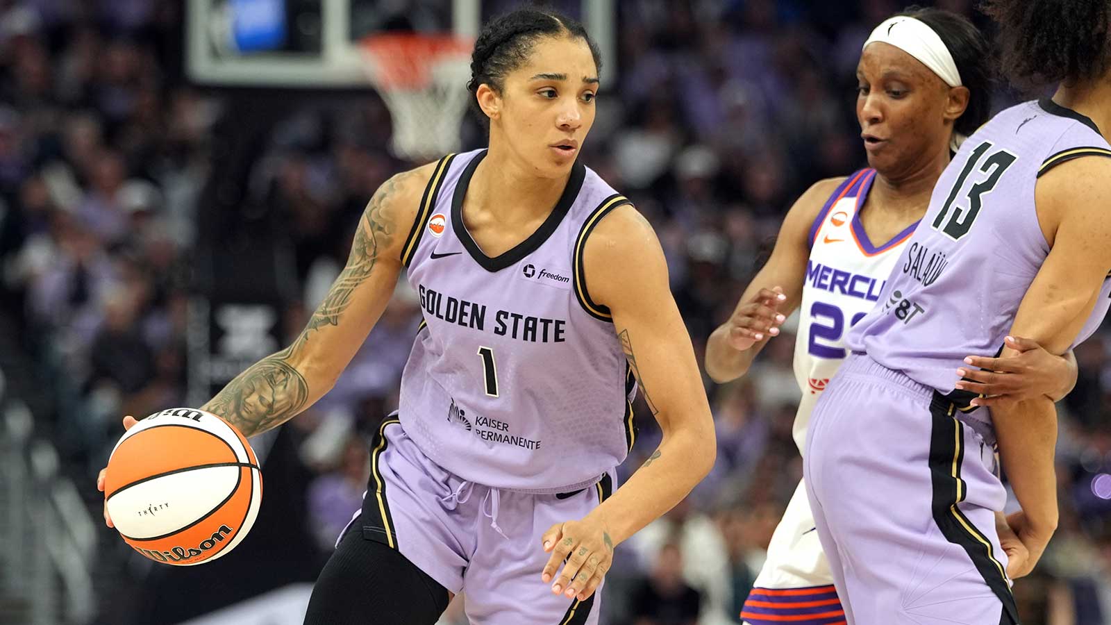 Golden State Valkyries forward Gabby Williams (1) dribbles around a screen set by forward Janelle Salaun (13) against Phoenix Mercury guard Kiana Williams (center right) during the fourth quarter at Chase Center. 