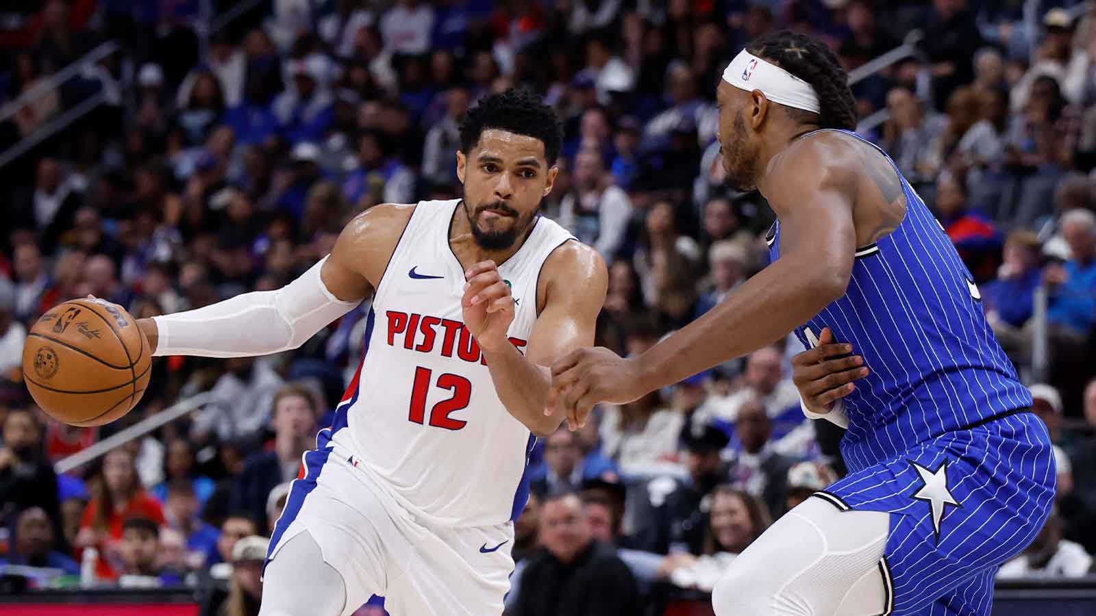 Pistons forward Tobias Harris (12) dribbles defended by Orlando Magic center Wendell Carter Jr. (34) in the second half during game seven of the first round of the 2026 NBA Playoffs at Little Caesars Arena