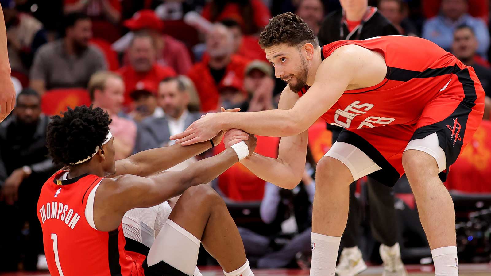 Rockets center Alperen Sengun (28) helps up Houston Rockets guard Amen Thompson (1) against the Los Angeles Lakers during the second quarter of game six of the first round of the 2026 NBA Playoffs at Toyota Center