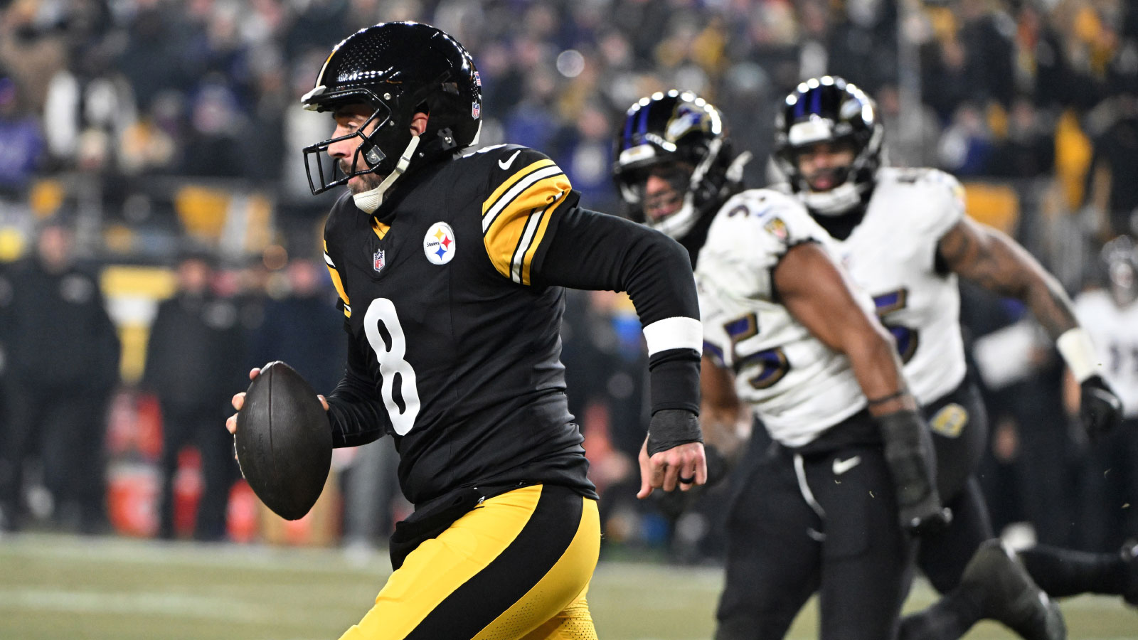 Pittsburgh Steelers quarterback Aaron Rodgers (8) rushes the ball against the Baltimore Ravens during the first half at Acrisure Stadium.