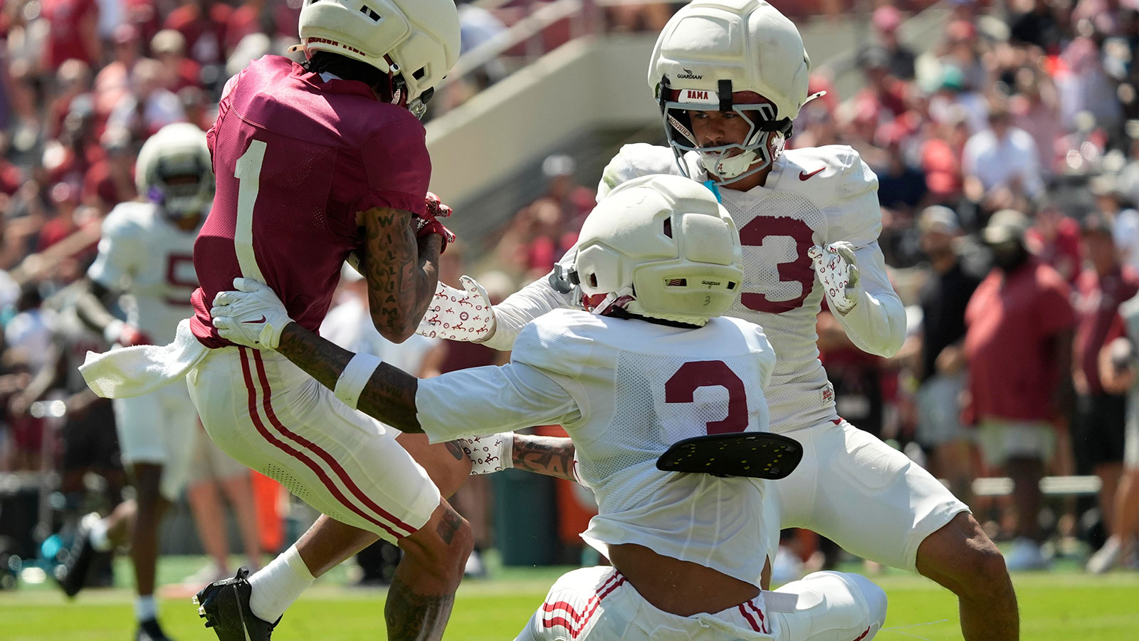 Alabama Crimson Tide wide receiver Ryan Coleman-Williams (1) makes a catch as he is defended by Alabama Crimson Tide defensive back Keon Sabb (3) and Alabama Crimson Tide defensive back Ivan Taylor (13) at Bryant-Denny Stadium during the Alabama A Day scrimmage.