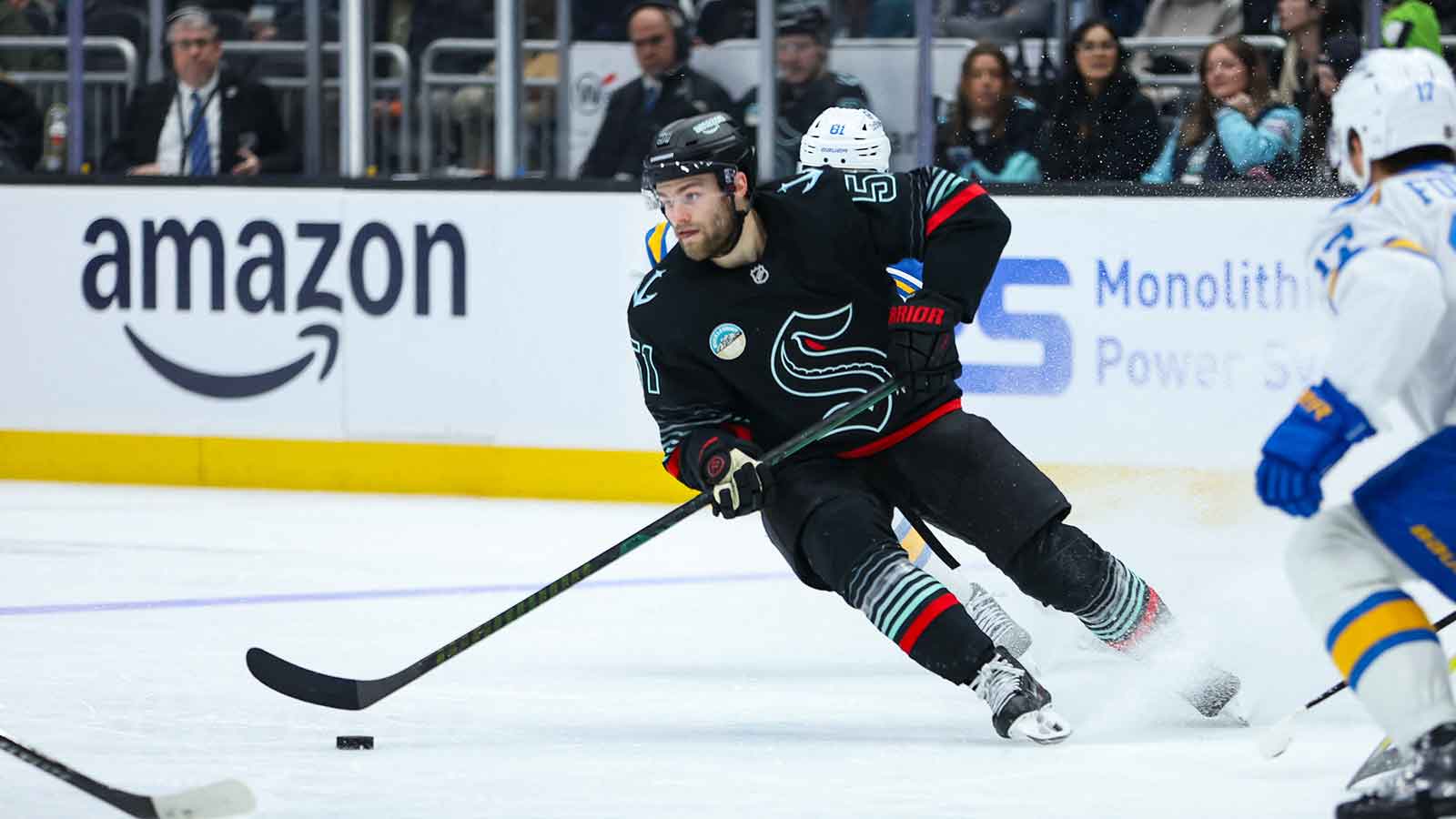  Seattle Kraken center Shane Wright (51) moves the puck in the second period against the St. Louis Blues at Climate Pledge Arena.