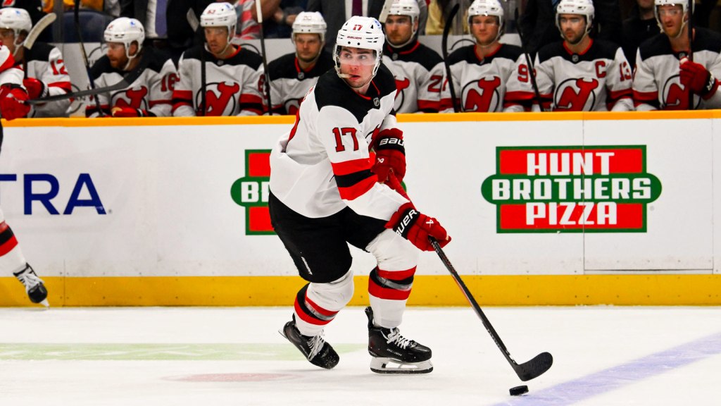 New Jersey Devils defenseman Simon Nemec (17) skates with the puck against the Nashville Predators during the first period at Bridgestone Arena.