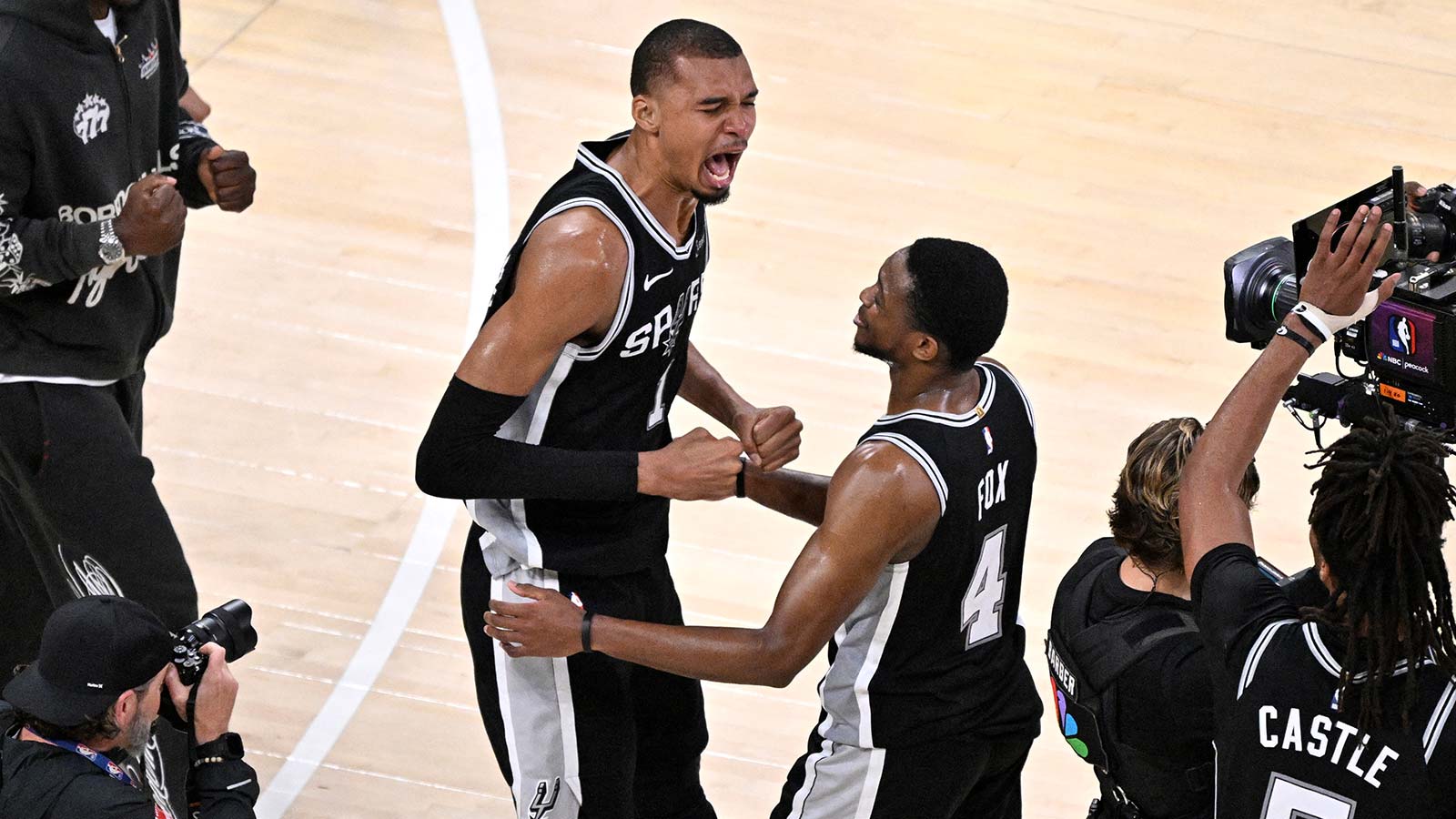 Spurs forward Victor Wembanyama (1) talks with Vince Carter after defeating the Oklahoma City Thunder in game seven of the western conference finals for the 2026 NBA playoffs at Paycom Center
