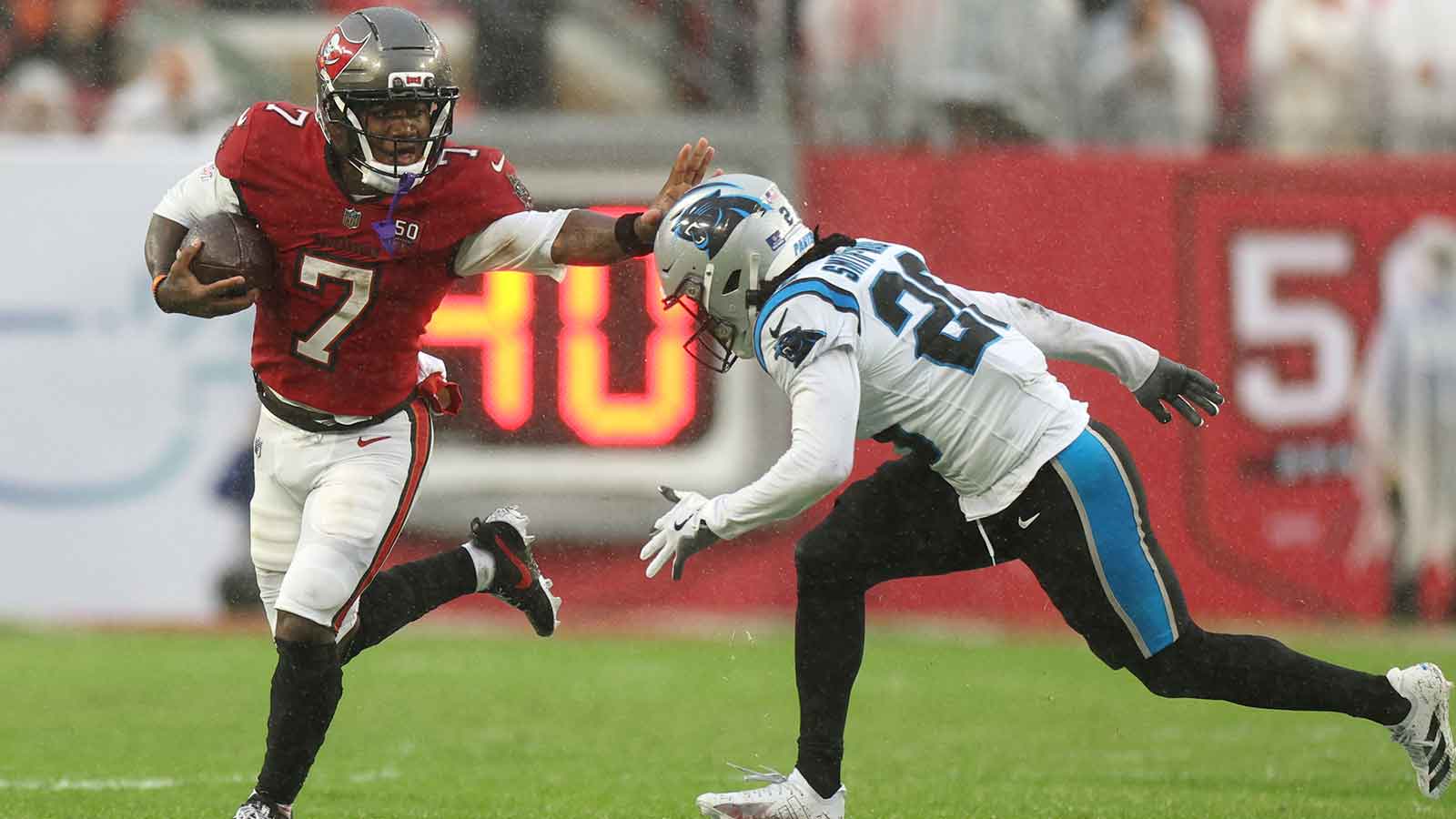 Tampa Bay Buccaneers running back Bucky Irving (7) runs against Carolina Panthers cornerback Chau Smith-Wade (26) in the first half at Raymond James Stadium.