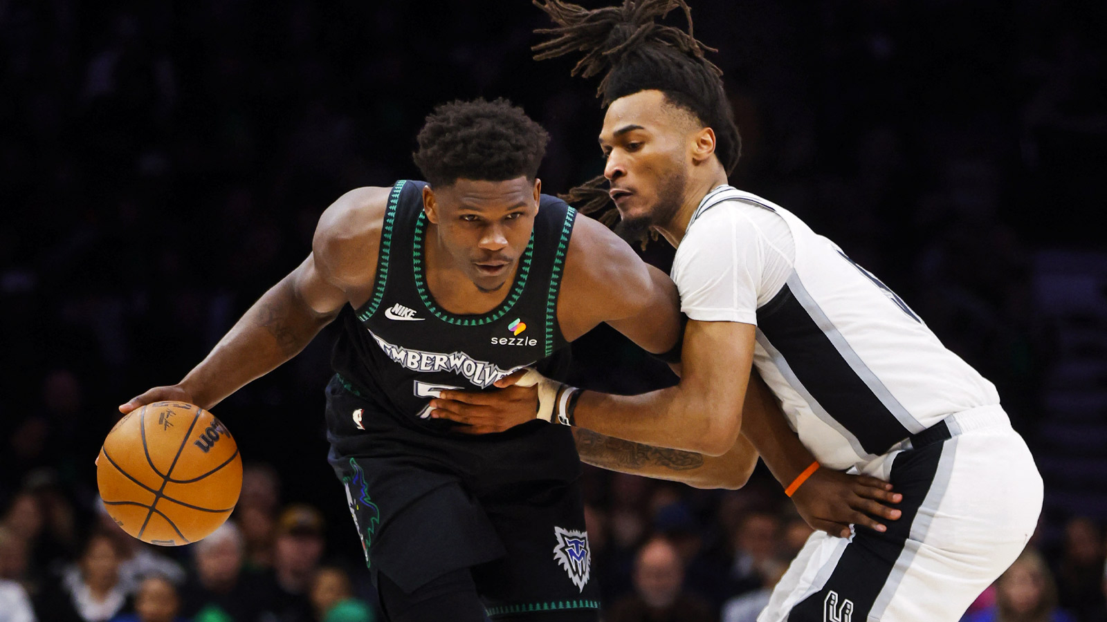 Minnesota Timberwolves guard Anthony Edwards (5) works around San Antonio Spurs guard Stephon Castle (5) in the fourth quarter of game four of the second round of the 2026 NBA Playoffs at Target Center. 