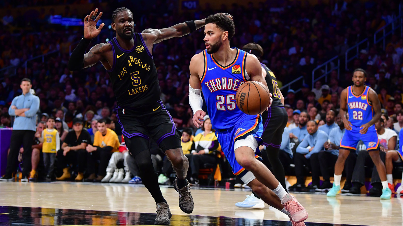 Thunder guard Ajay Mitchell (25) moves the ball against Los Angeles Lakers center Deandre Ayton (5) during the second half in game four of the second round of the 2026 NBA Playoffs at Crypto.com Arena