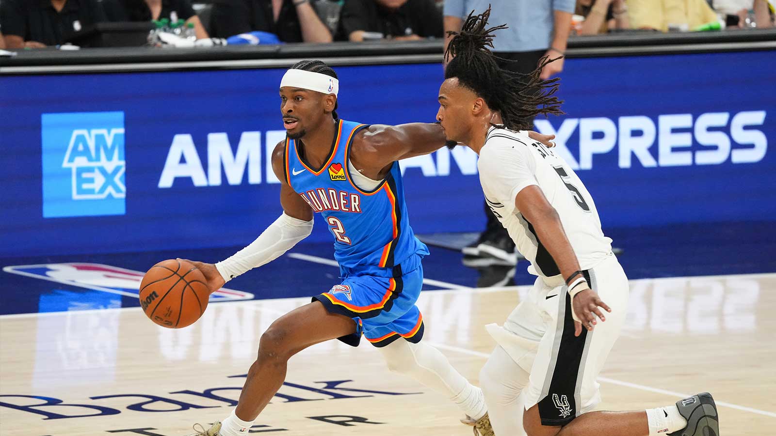 Thunder guard Shai Gilgeous-Alexander (2) moves the ball past San Antonio Spurs guard Stephon Castle (5) in the second quarter during game four of the western conference finals for the 2026 NBA playoffs at Frost Bank Center