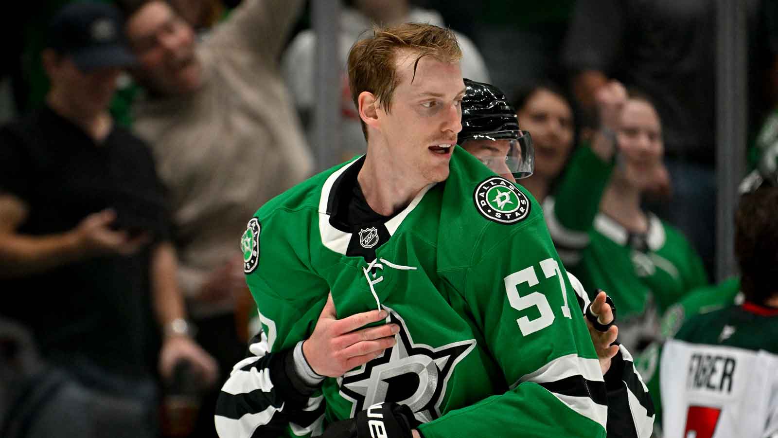 Dallas Stars defenseman Tyler Myers (57) is held back by the referees during the second period against the Minnesota Wild at the American Airlines Center.