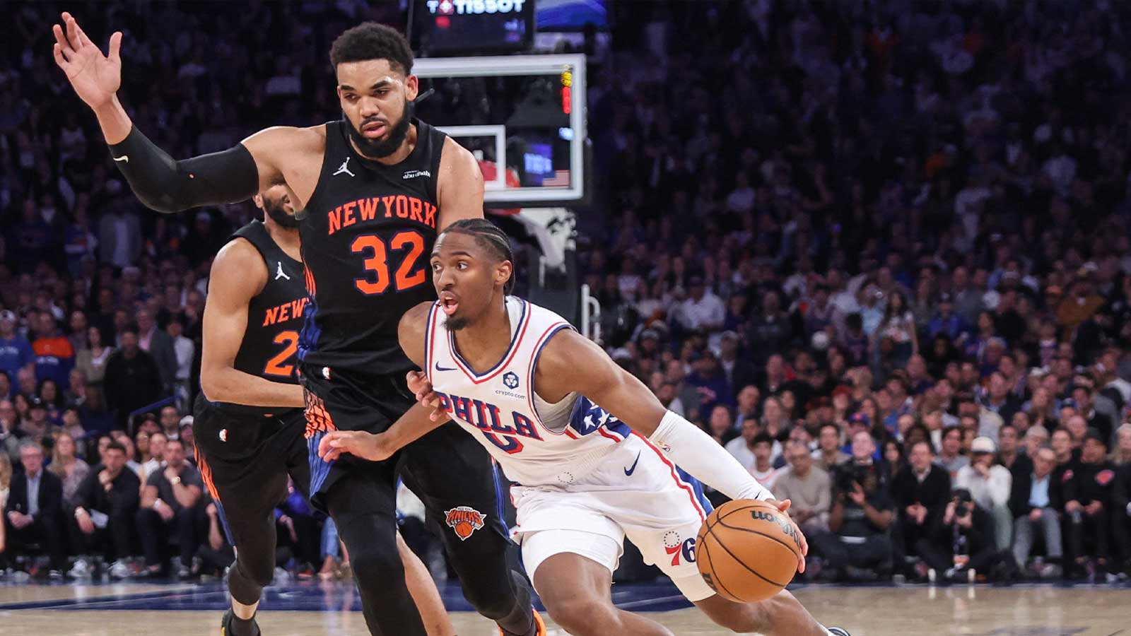 Philadelphia 76ers guard Tyrese Maxey (0) drives past New York Knicks center Karl-Anthony Towns (32) during game five of the second round of the 2026 NBA Playoffs at Madison Square Garden. 