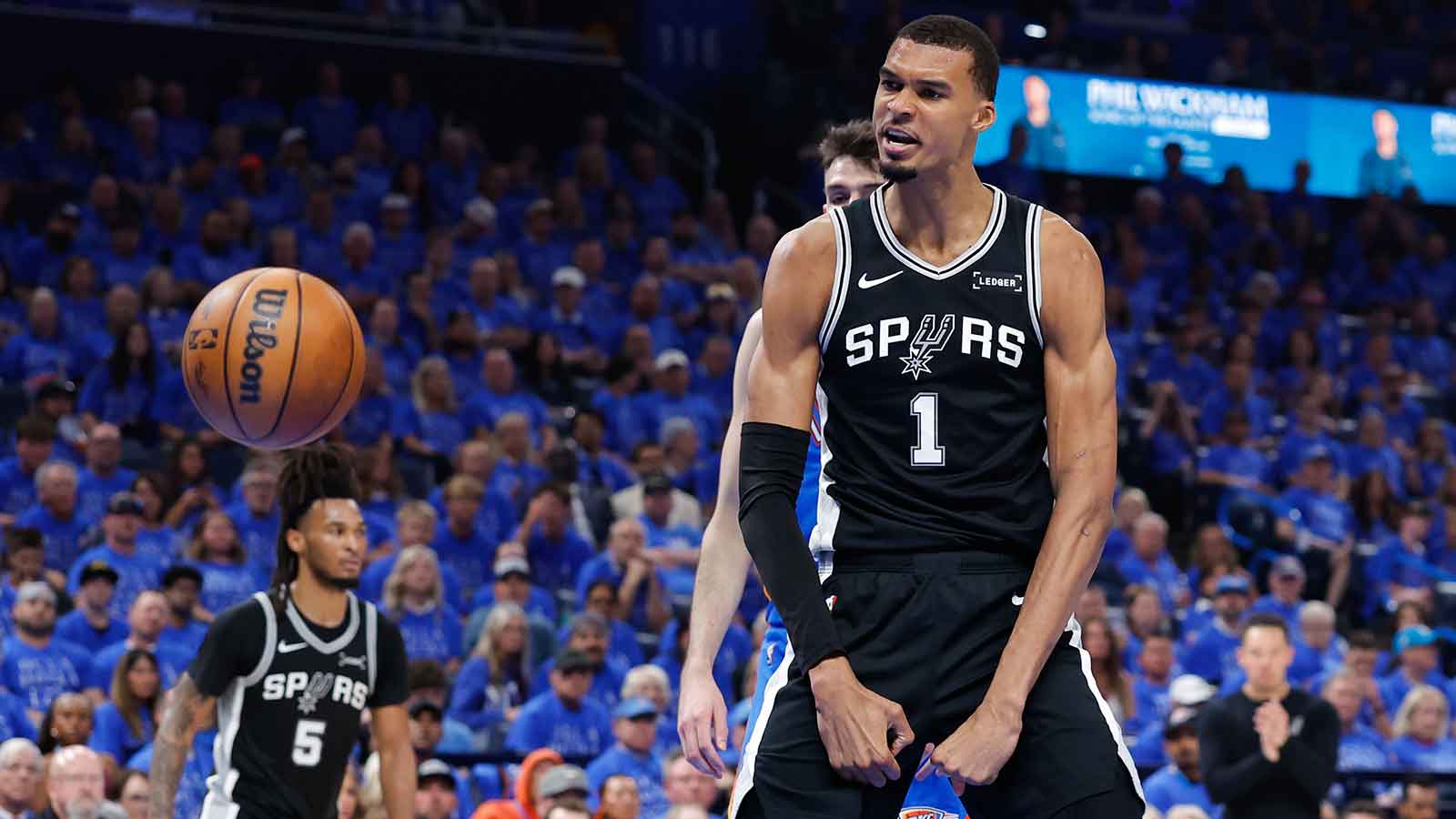 San Antonio Spurs center Victor Wembanyama (1) reacts after a dunk in the second quarter against the Oklahoma City Thunder during game one of the western conference finals for the 2026 NBA playoffs at Paycom Center.