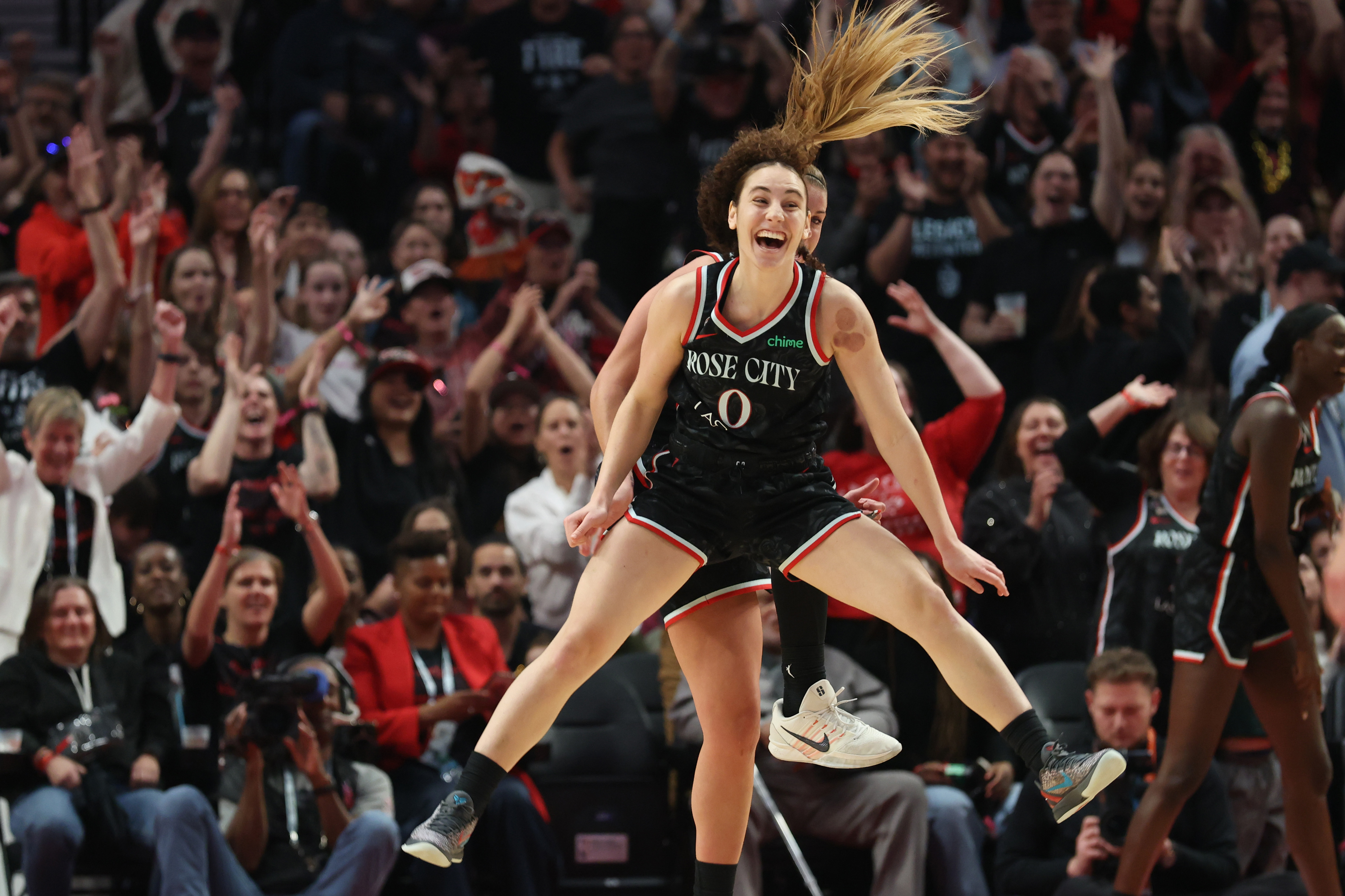 Portland Fire guard Carla Leite (0) and guard Sarah Ashlee Barker (3) celebrate after Barker scored against the Indiana Fever during the second half at Moda Center. 