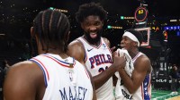 Philadelphia 76ers center Joel Embiid (21) celebrates with guard Tyrese Maxey (0) and guard Vj Edgecombe (77)] following their win over the Boston Celtics in game seven of the first round of the 2026 NBA Playoffs at TD Garden.