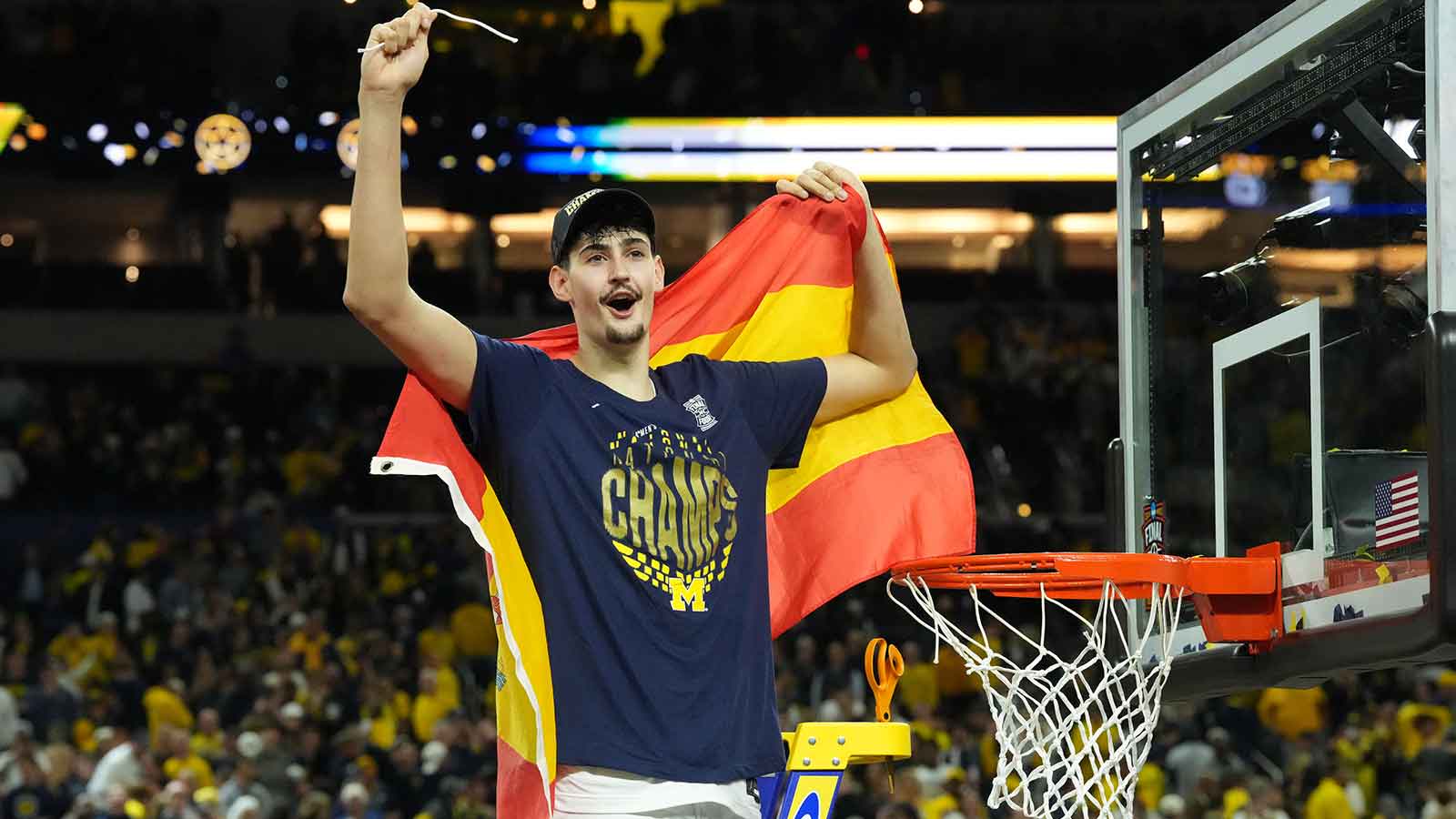 Michigan Wolverines center Aday Mara (15) celebrates after cutting down a piece of the net after defeating the Connecticut Huskies in the national championship of the Final Four of the men's 2026 NCAA Tournament at Lucas Oil Stadium.