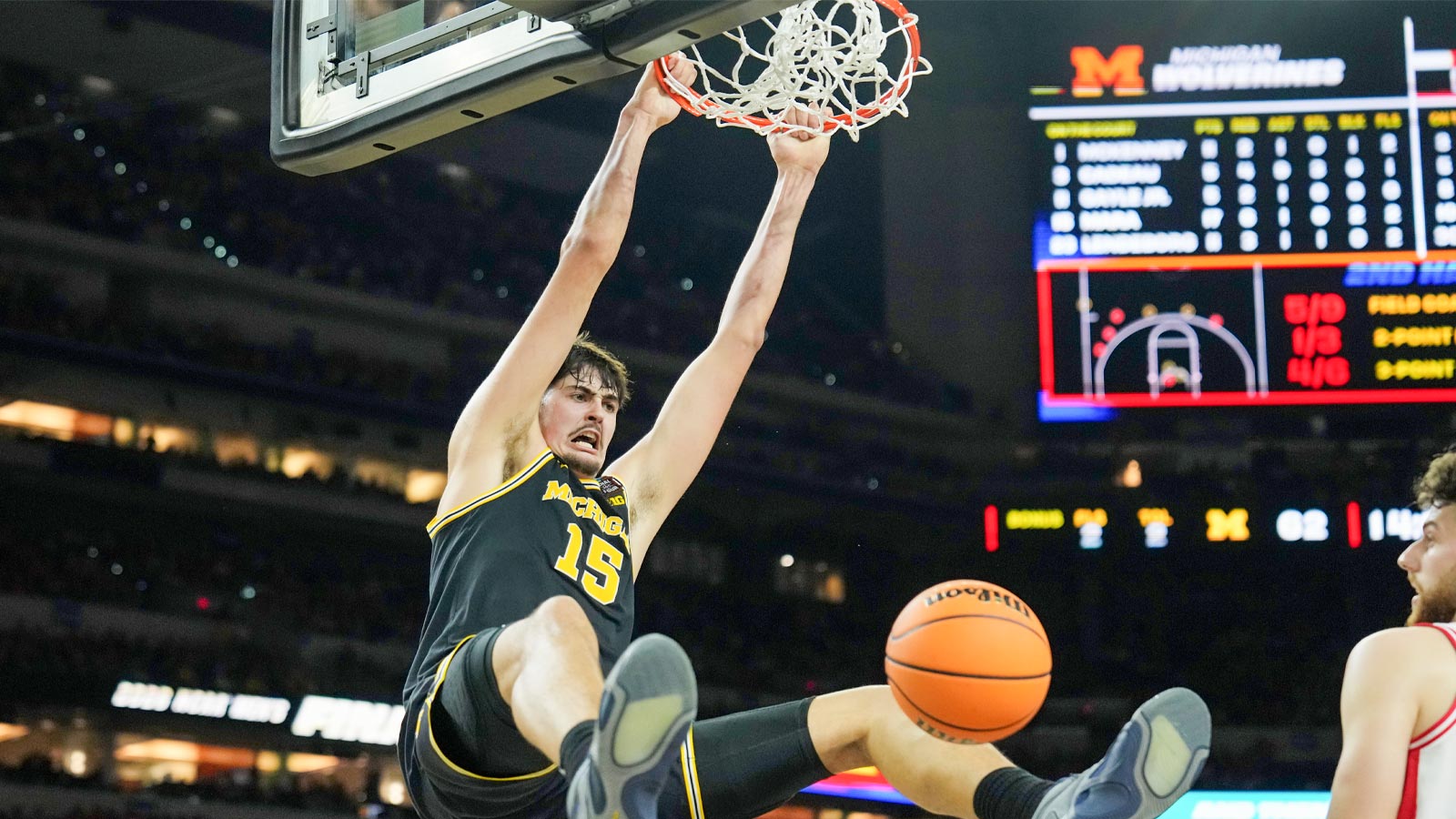 Michigan Wolverines center Aday Mara (15) dunks against the Arizona Wildcats during the second half in a semifinal of the Final Four of the men's 2026 NCAA Tournament at Lucas Oil Stadium.