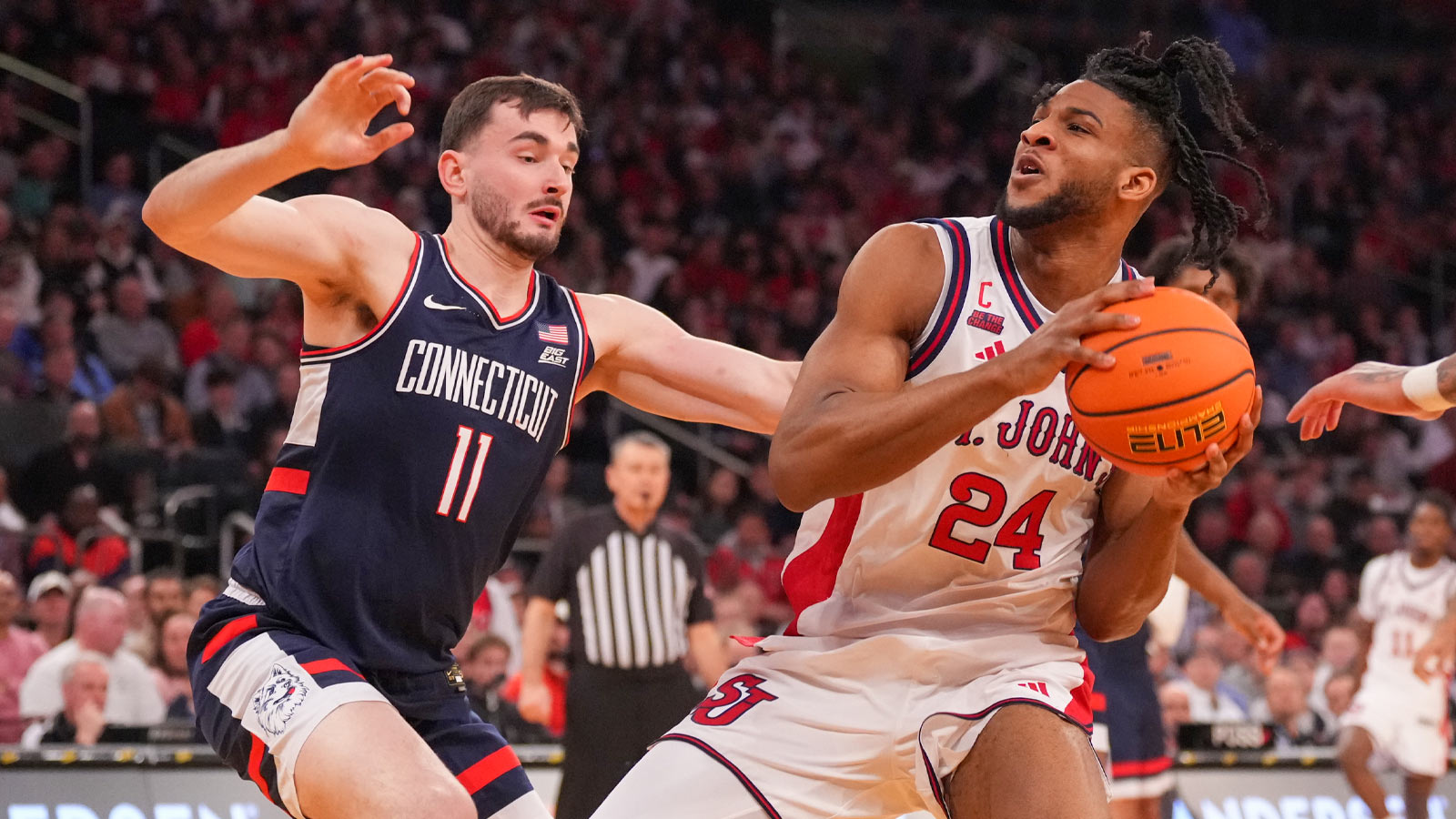 St. John's Red Storm forward Zuby Ejiofor (24) looks to shoot over Connecticut Huskies forward Alex Karaban (11) during the first half of the men's Big East Conference Tournament Championship at Madison Square Garden.