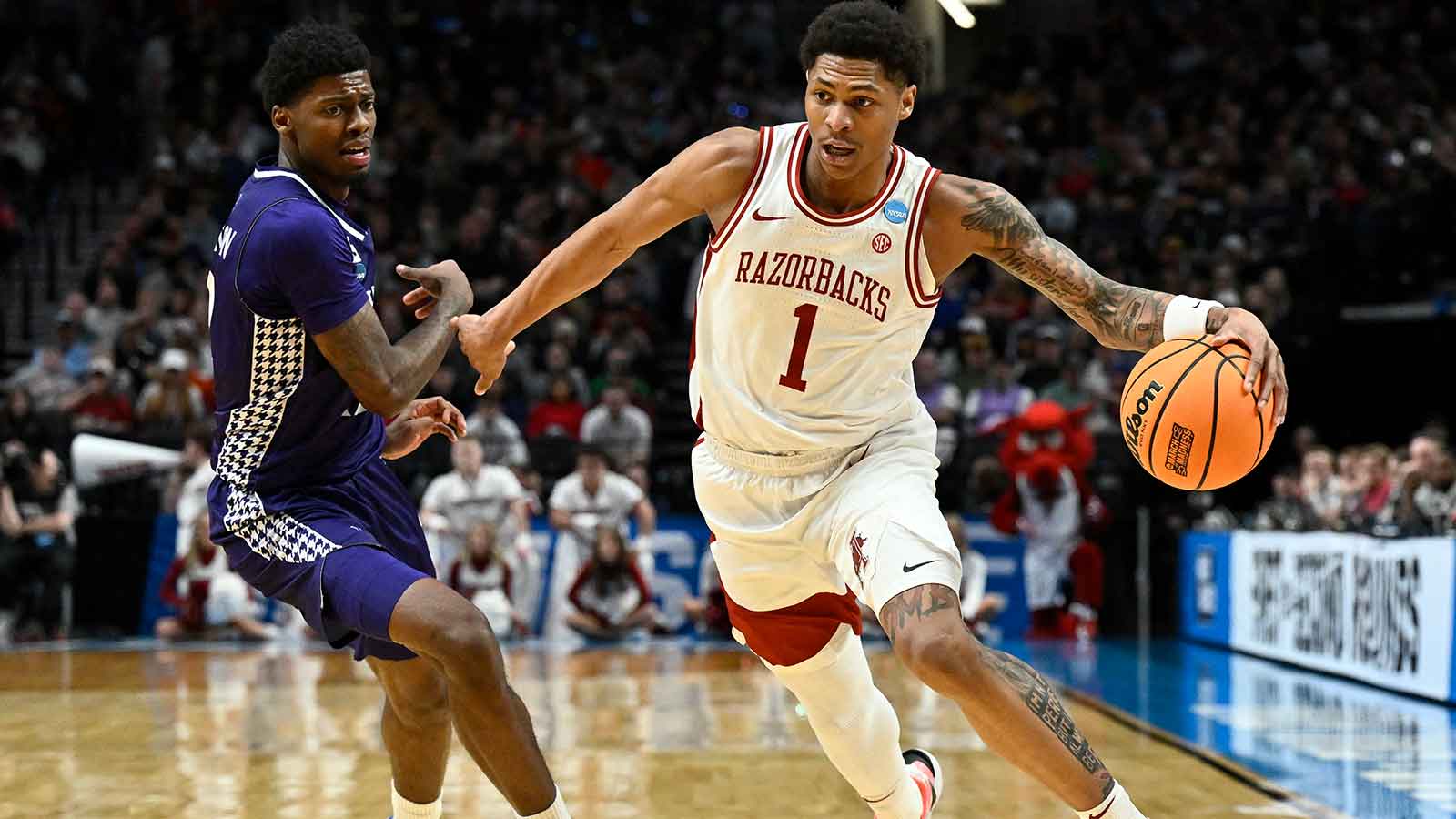 Arkansas Razorbacks guard Meleek Thomas (1) drives against High Point Panthers guard Scotty Washington (12)
