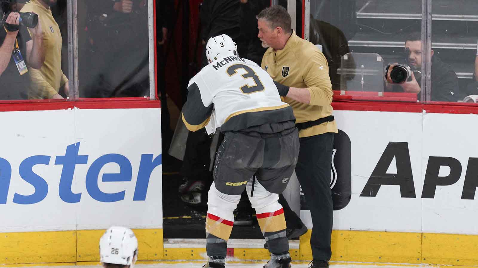 Vegas Golden Knights defenseman Brayden McNabb (3) is assisted off the ice after a puck to the face during the first period against the Carolina Hurricanes in game two of the 2026 Stanley Cup Final at Lenovo Center.