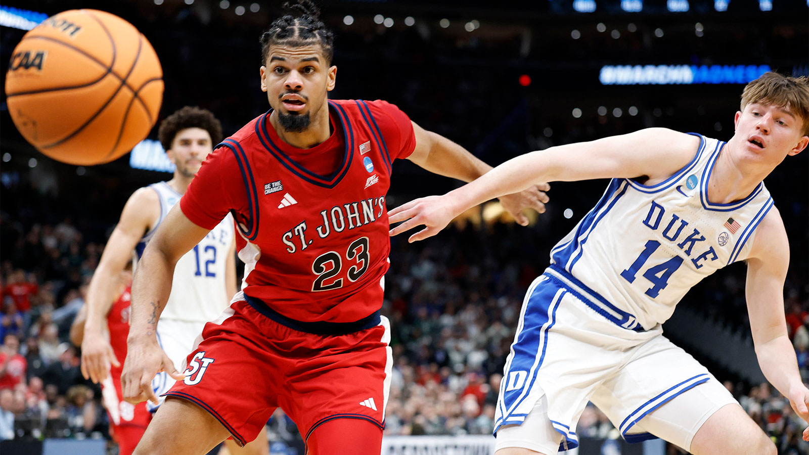 St. John's Red Storm forward Bryce Hopkins (23) and Duke Blue Devils guard Nikolas Khamenia (14) attempt to get a rebound in the second half during a Sweet Sixteen game of the East Regional of the men's 2026 NCAA Tournament at Capital One Arena. 
