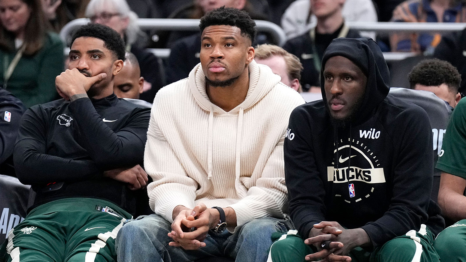 Milwaukee Bucks guard Gary Harris (11), left, Milwaukee Bucks forward Giannis Antetokounmpo (34) and Milwaukee Bucks forward Taurean Prince (12) watch the game against the Cleveland Cavaliers from the bench in the second half at Fiserv Forum.