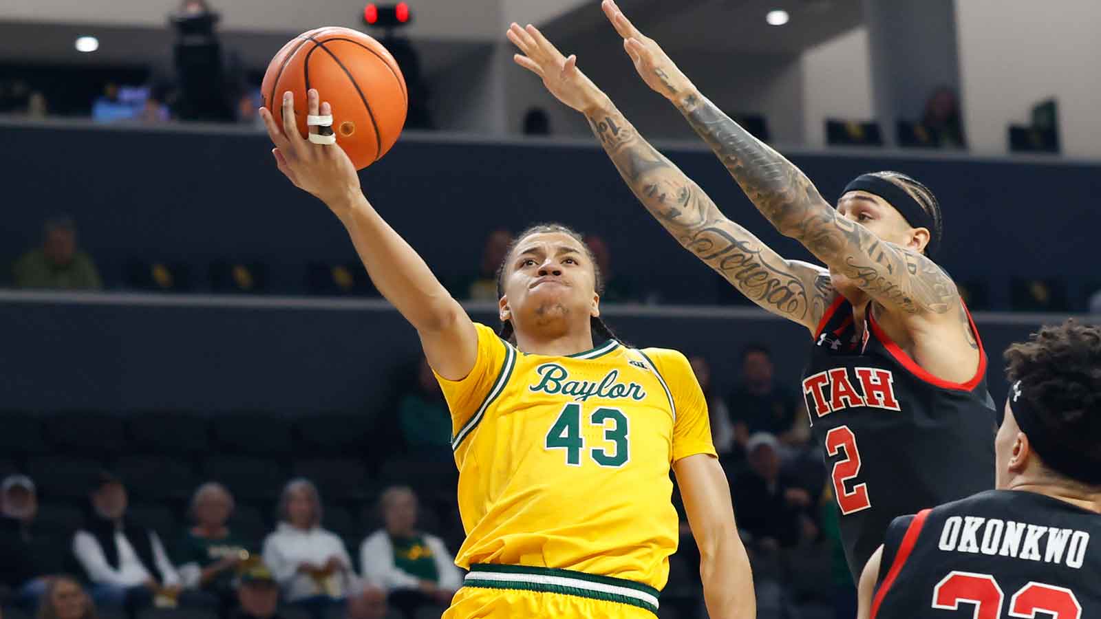Baylor Bears guard Cameron Carr (43) scores a layup as Utah Utes guard Terrence Brown (2) defends during the first half at Paul and Alejandra Foster Pavilion. Mandatory Credit: