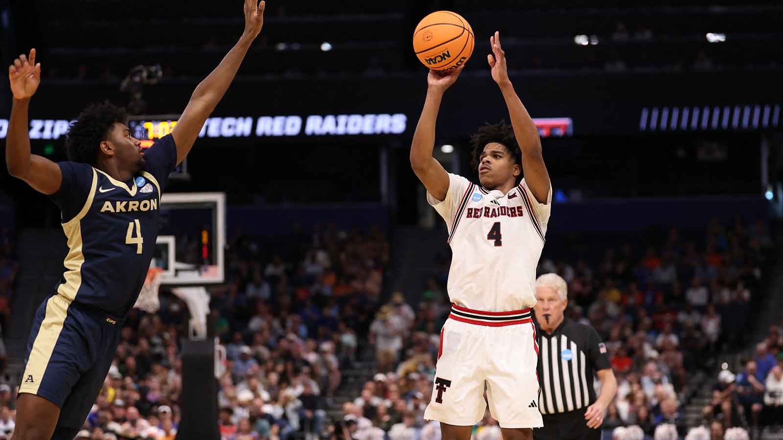 Texas Tech Red Raiders guard Christian Anderson (4) shoots against Akron Zips guard Eric Mahaffey (4) in the first half during a first round game of the men's 2026 NCAA Tournament at Benchmark International Arena.