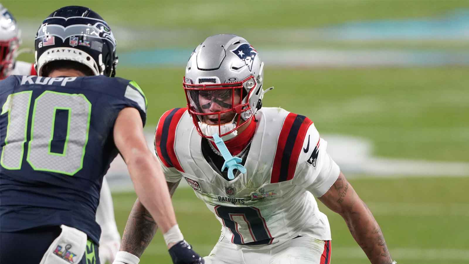 New England Patriots cornerback Christian Gonzalez (0) defends against Seattle Seahawks wide receiver Cooper Kupp (10) during the third quarter in Super Bowl LX at Levi's Stadium. 