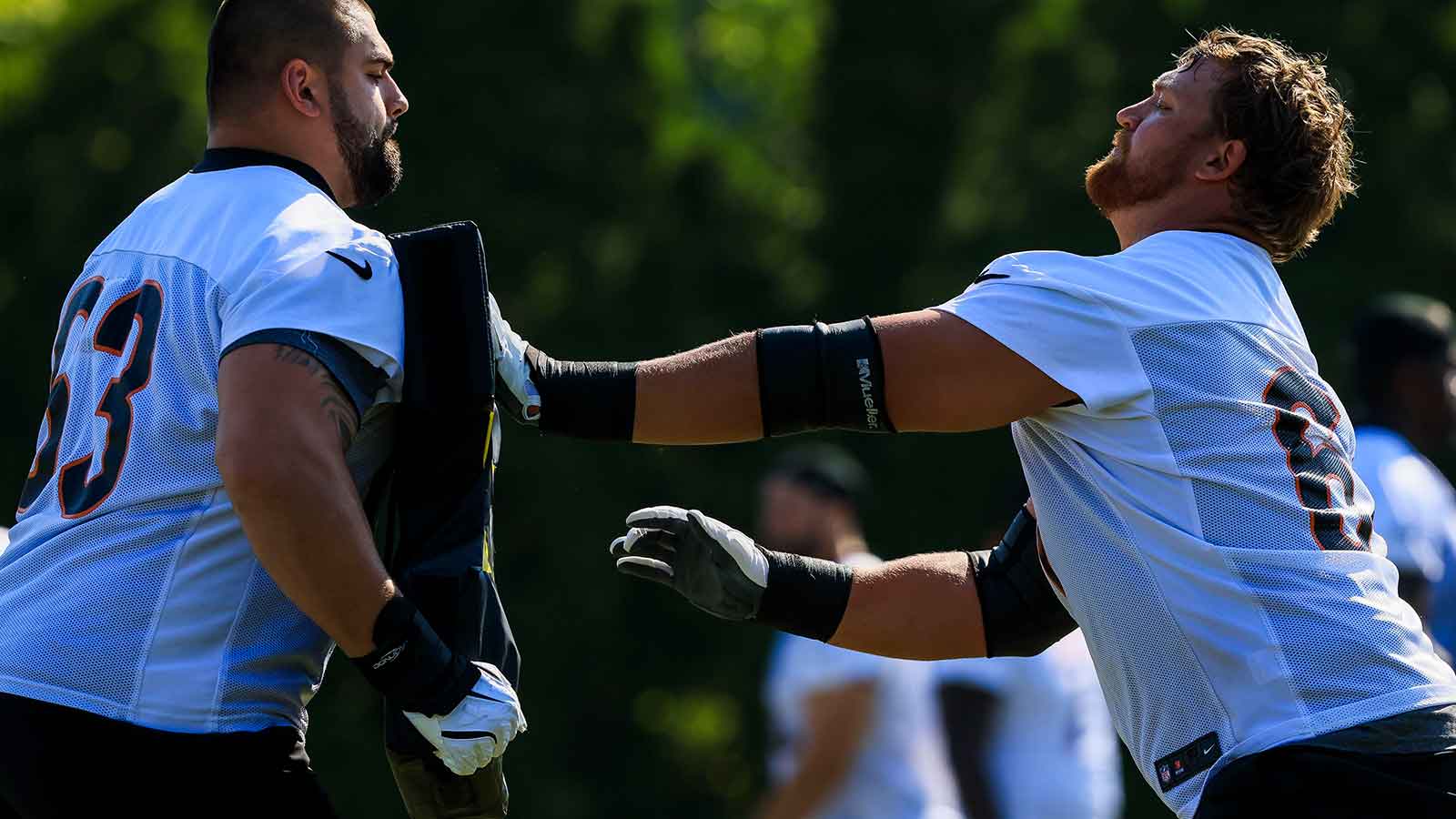 Cincinnati Bengals guard Dylan Fairchild (63) warms up with guard Cordell Volson (67) during training camp at Kettering Health Practice Field. 