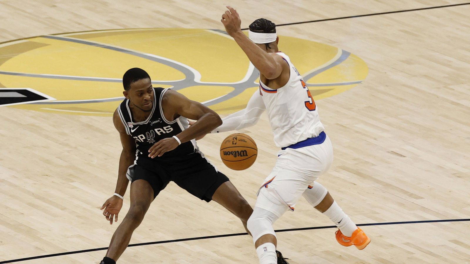 New York Knicks guard Josh Hart (3) steals the bal from San Antonio Spurs guard De'aaron Fox (4) in the second half during game one of the 2026 NBA Finals at Frost Bank Center.