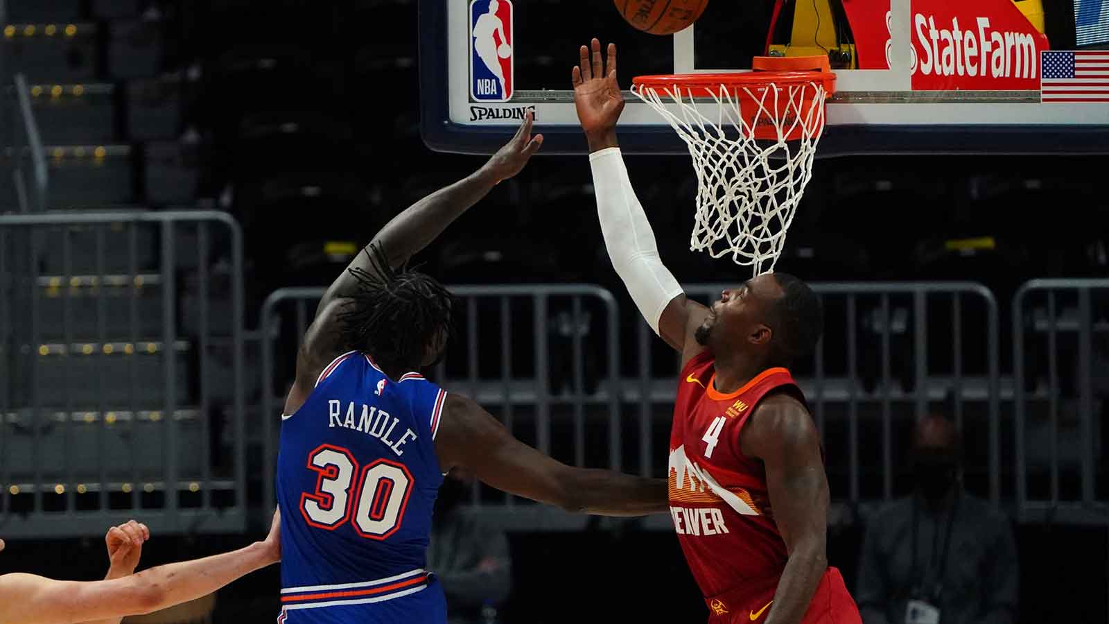 New York Knicks forward Julius Randle (30) shoots the ball over Denver Nuggets forward Paul Millsap (4) in the second quarter at Ball Arena. Mandatory Credit: Ron Chenoy-Imagn Images