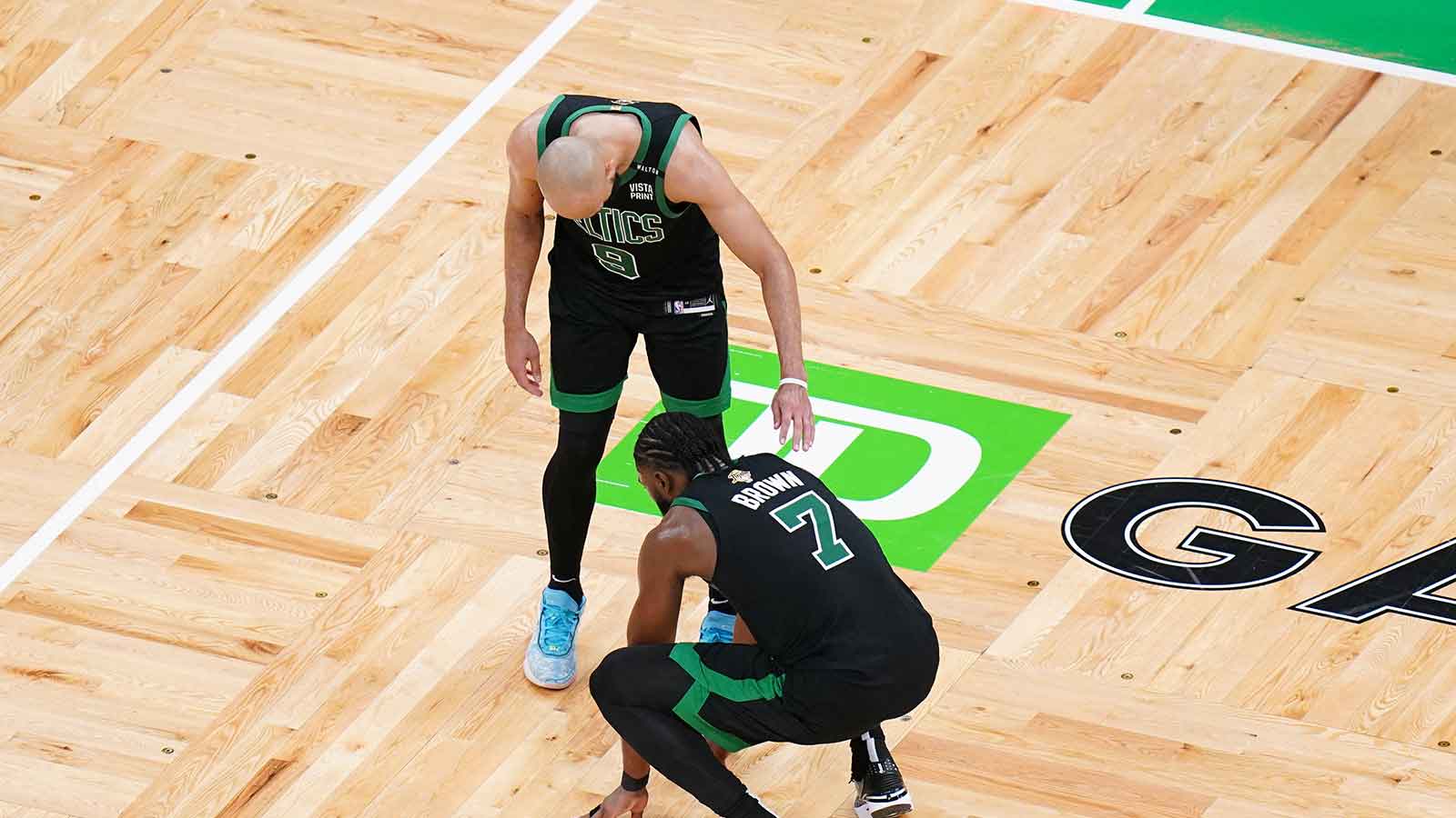 Boston Celtics guard Jaylen Brown (7) reacts with guard Derrick White (9) after defeating the Dallas Mavericks in game two of the 2024 NBA Finals at TD Garden. 