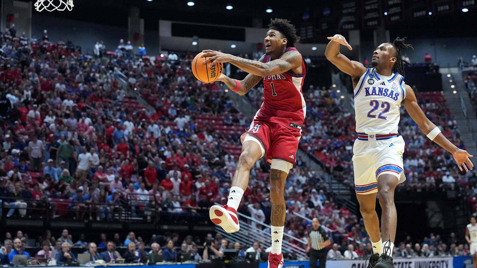 St. John's Red Storm forward Dillon Mitchell (1) shoots against Kansas Jayhawks guard Darryn Peterson (22) in the first half during a second round game of the men's 2026 NCAA Tournament at Viejas Arena. 