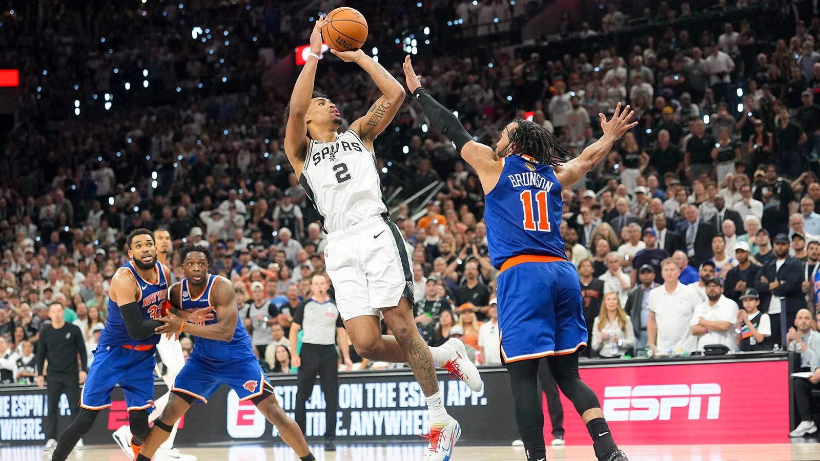 San Antonio Spurs guard Dylan Harper (2) shoots the ball over New York Knicks guard Jalen Brunson (11) in the fourth quarter during game two of the 2026 NBA Finals at Frost Bank Center.