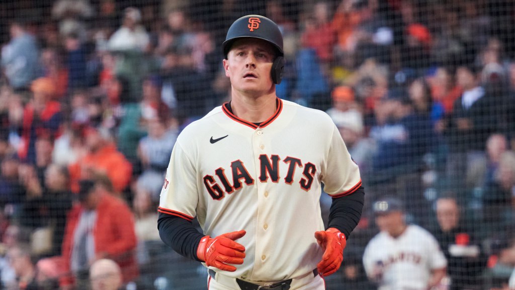 San Francisco Giants infielder Matt Chapman (26) returns to the dugout after scoring a run against the New York Mets during the second inning at Oracle Park.