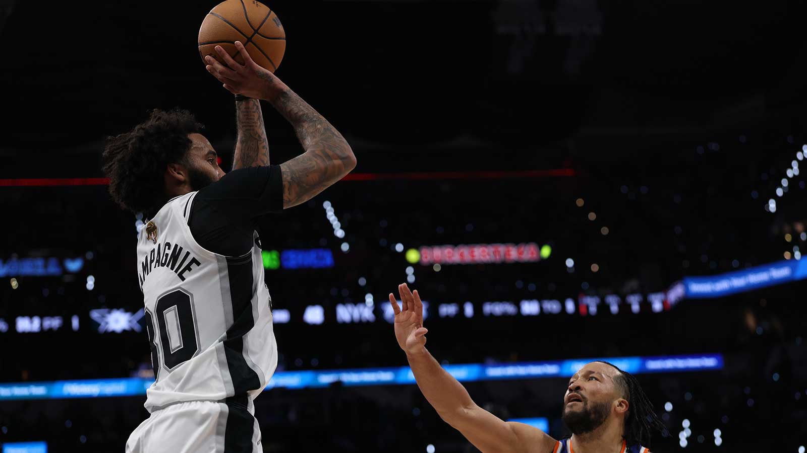 San Antonio Spurs forward Julian Champagnie (30) shoots over New York Knicks guard Jalen Brunson (11) during game five of the 2026 NBA Finals at Frost Bank Center.