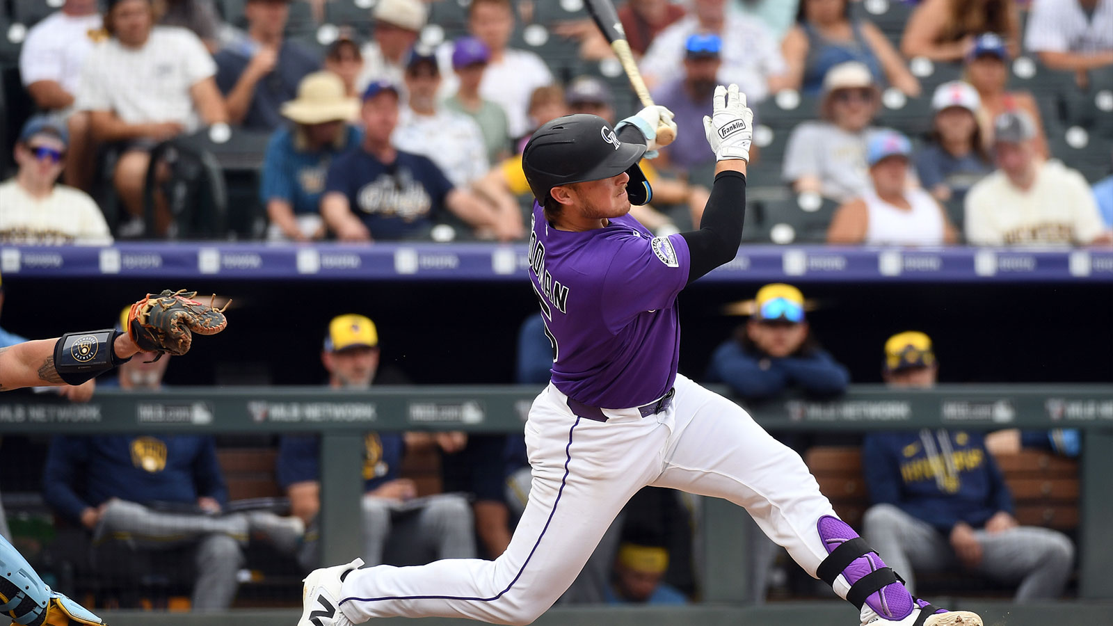 Colorado Rockies catcher Hunter Goodman (15) hits a home run in the ninth inning against the Milwaukee Brewers at Coors Field. 