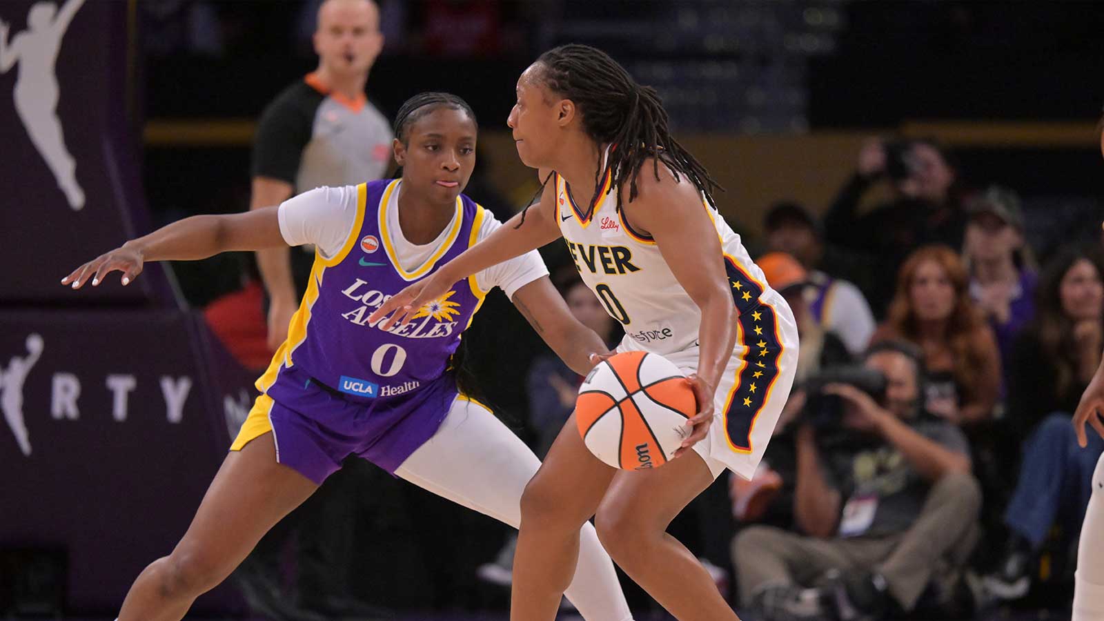 Los Angeles Sparks guard Ta'niya Latson (0) defends Indiana Fever guard Kelsey Mitchell (0) in the first half at Crypto.com Arena.