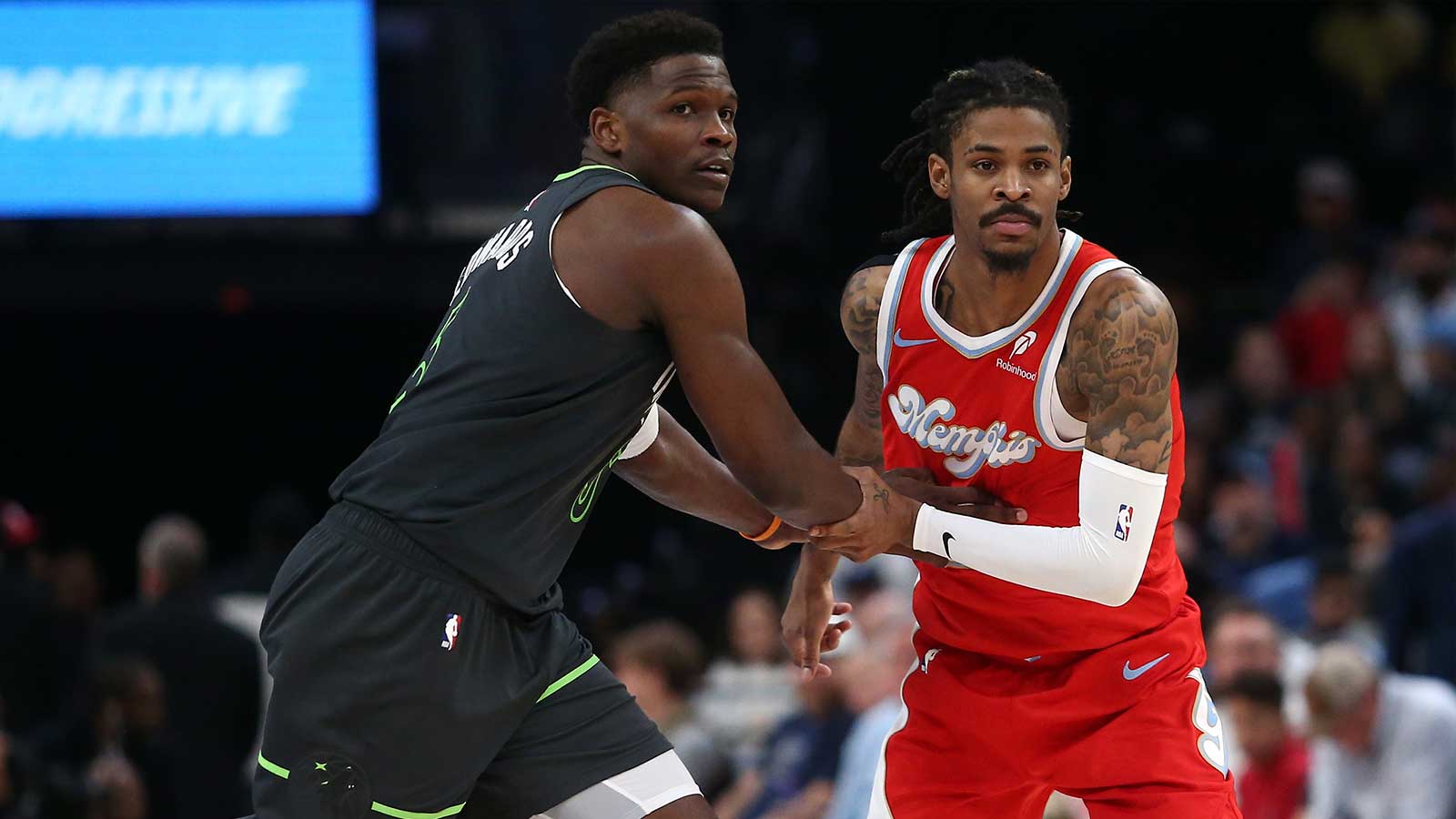 Minnesota Timberwolves guard Anthony Edwards (5) and Memphis Grizzlies guard Ja Morant (12) battle for position during the third quarter at FedExForum. 