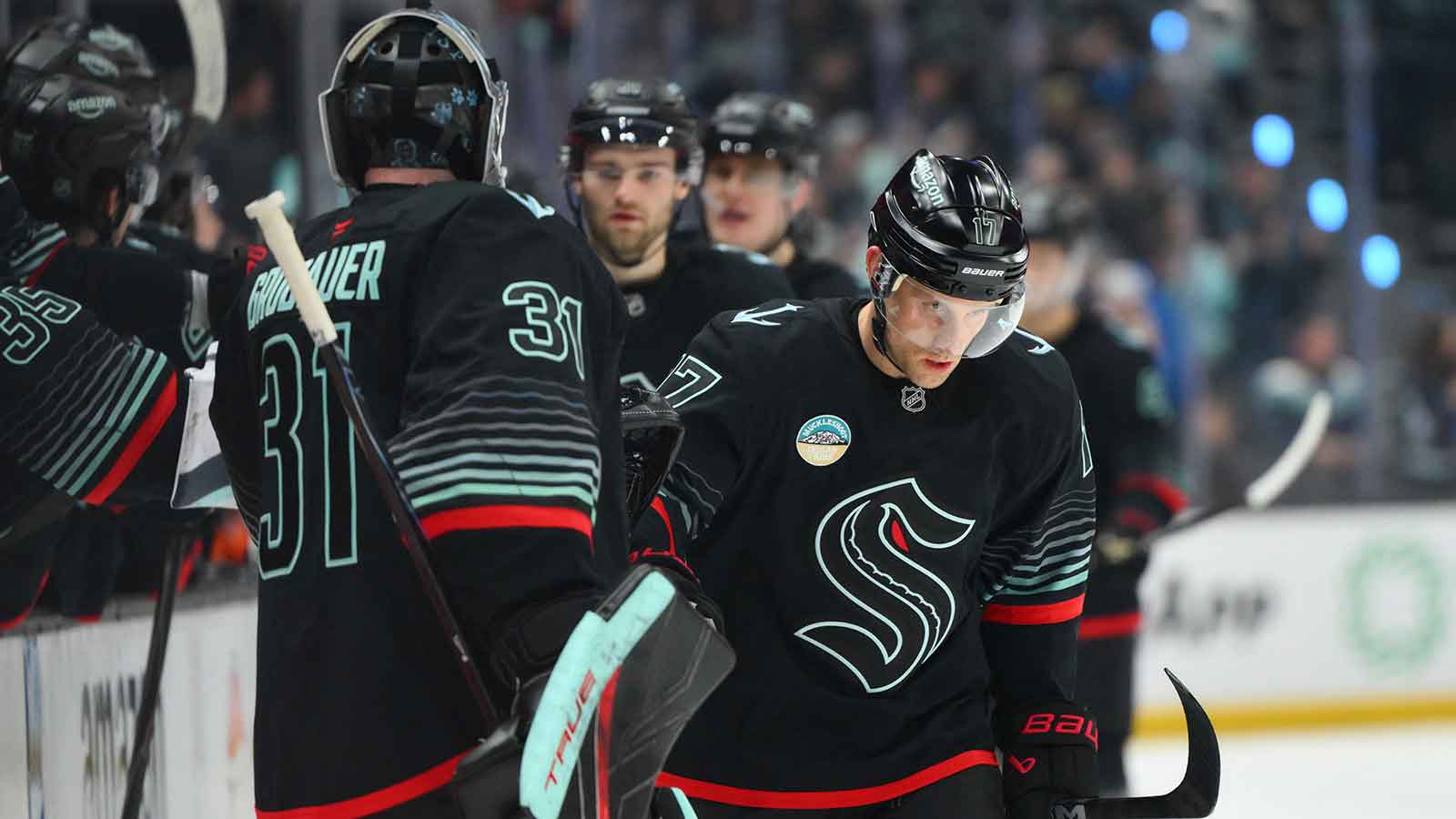 Seattle Kraken left wing Jaden Schwartz (17) celebrates with goaltender Philipp Grubauer (31) after scoring a goal against the Anaheim Ducks during the third period at Climate Pledge Arena.