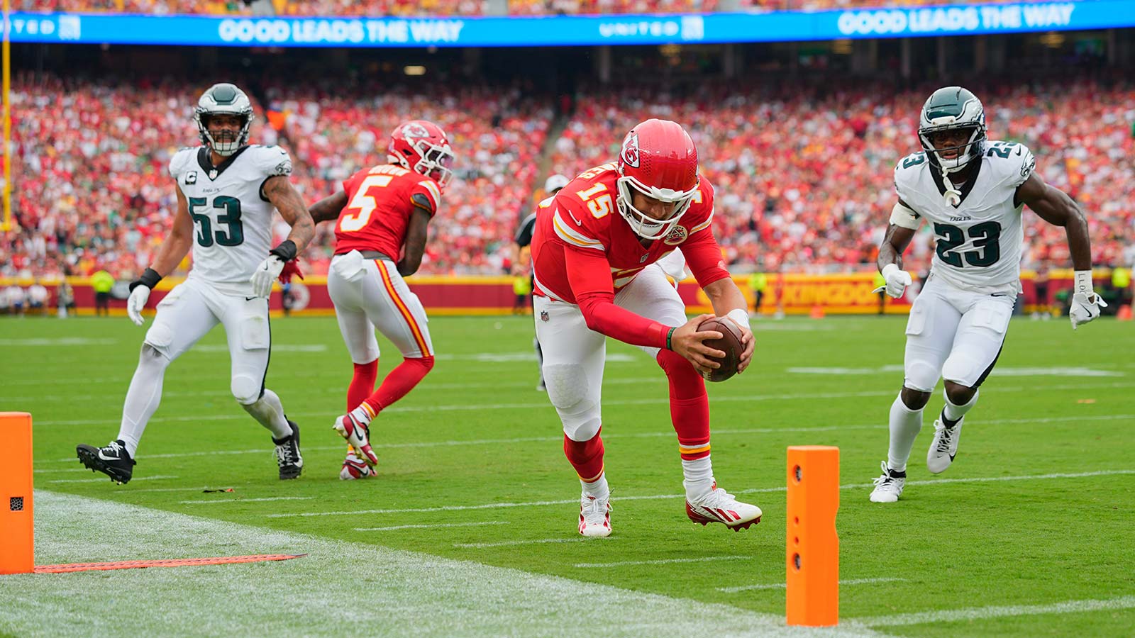 Kansas City Chiefs quarterback Patrick Mahomes (15) scores a touchdown defended by Philadelphia Eagles linebacker Zack Baun (53) and cornerback Jakorian Bennett (23) during the second quarter of the game at GEHA Field at Arrowhead Stadium. 