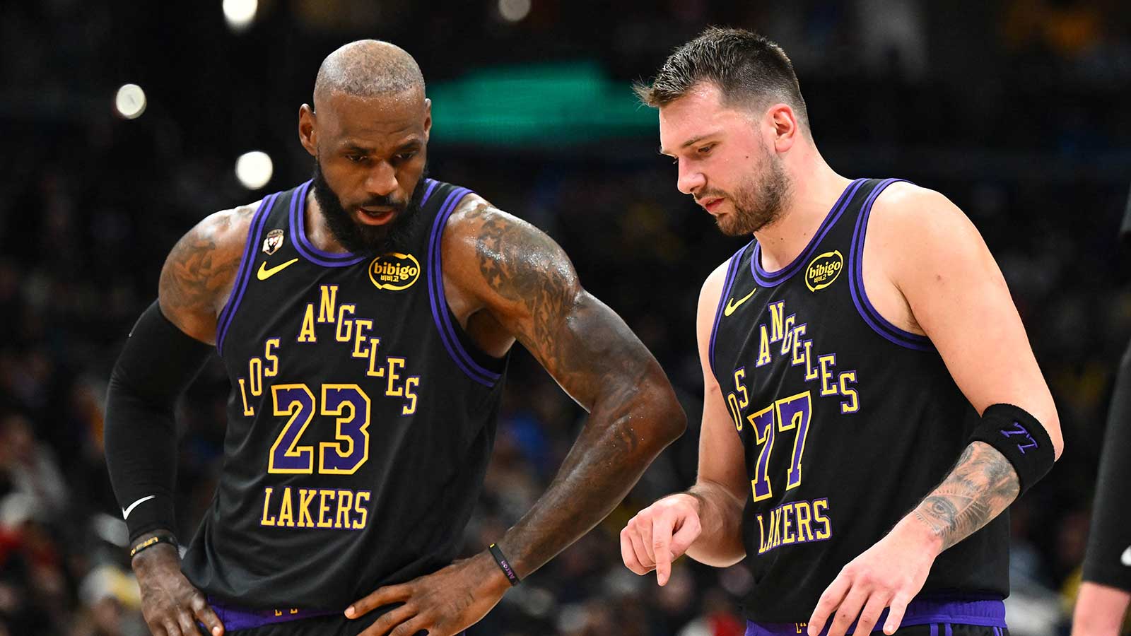 Los Angeles Lakers forward/guard Luka Doncic (77) talks with Los Angeles Lakers forward LeBron James (23) against the Washington Wizards during the second half at Capital One Arena.