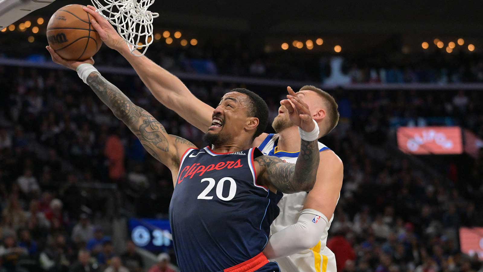 Golden State Warriors center Kristaps Porzingis (7) blocks a shot by Los Angeles Clippers forward John Collins (20) in the first half during the play-in rounds of the 2026 NBA Playoffs at Intuit Dome. 